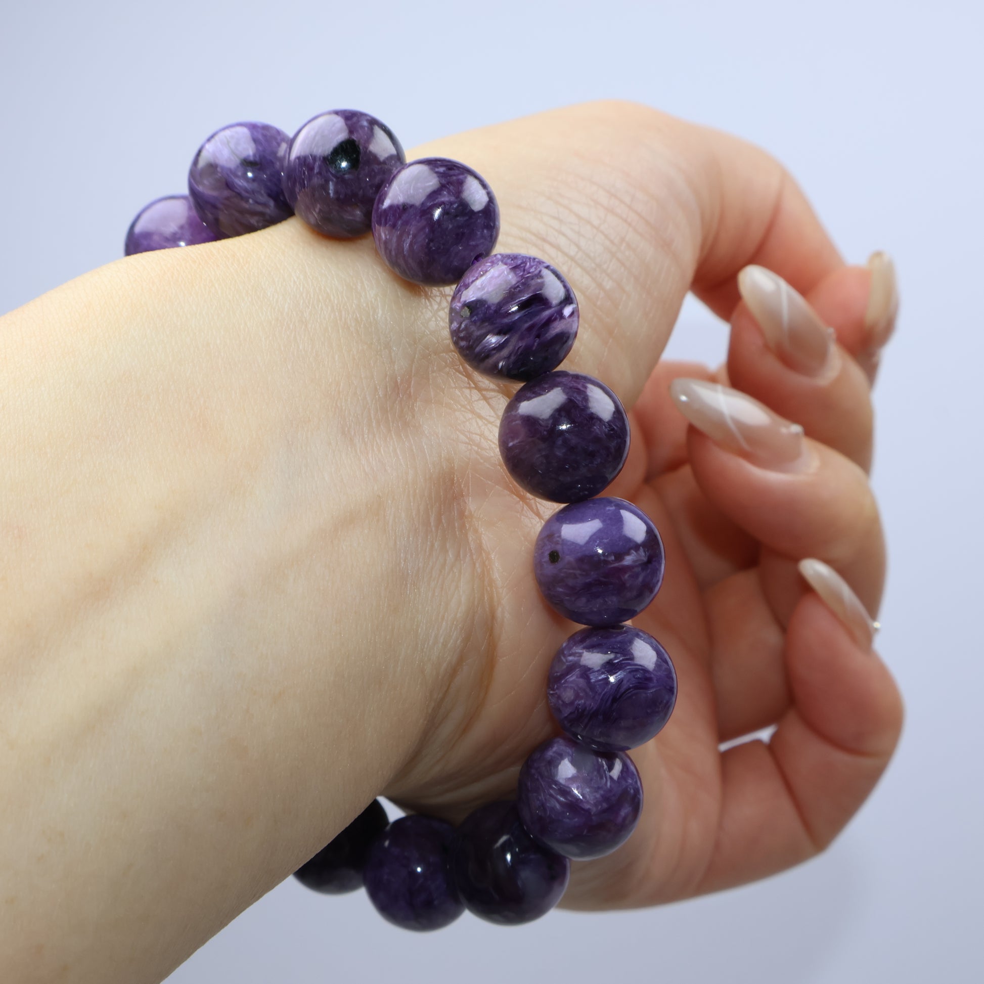 Back-hand view wearing Charoite bracelet showing fit and shape