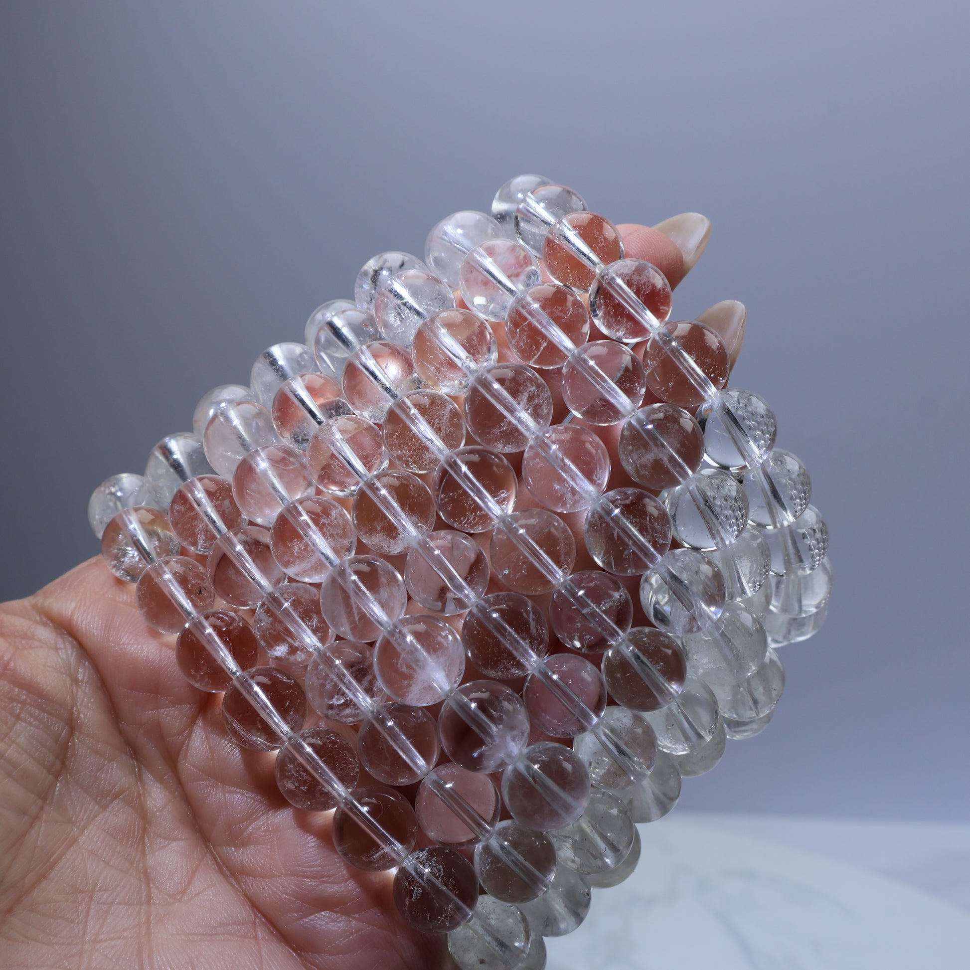 Stack of multiple white quartz bracelets – budget-friendly crystal basics