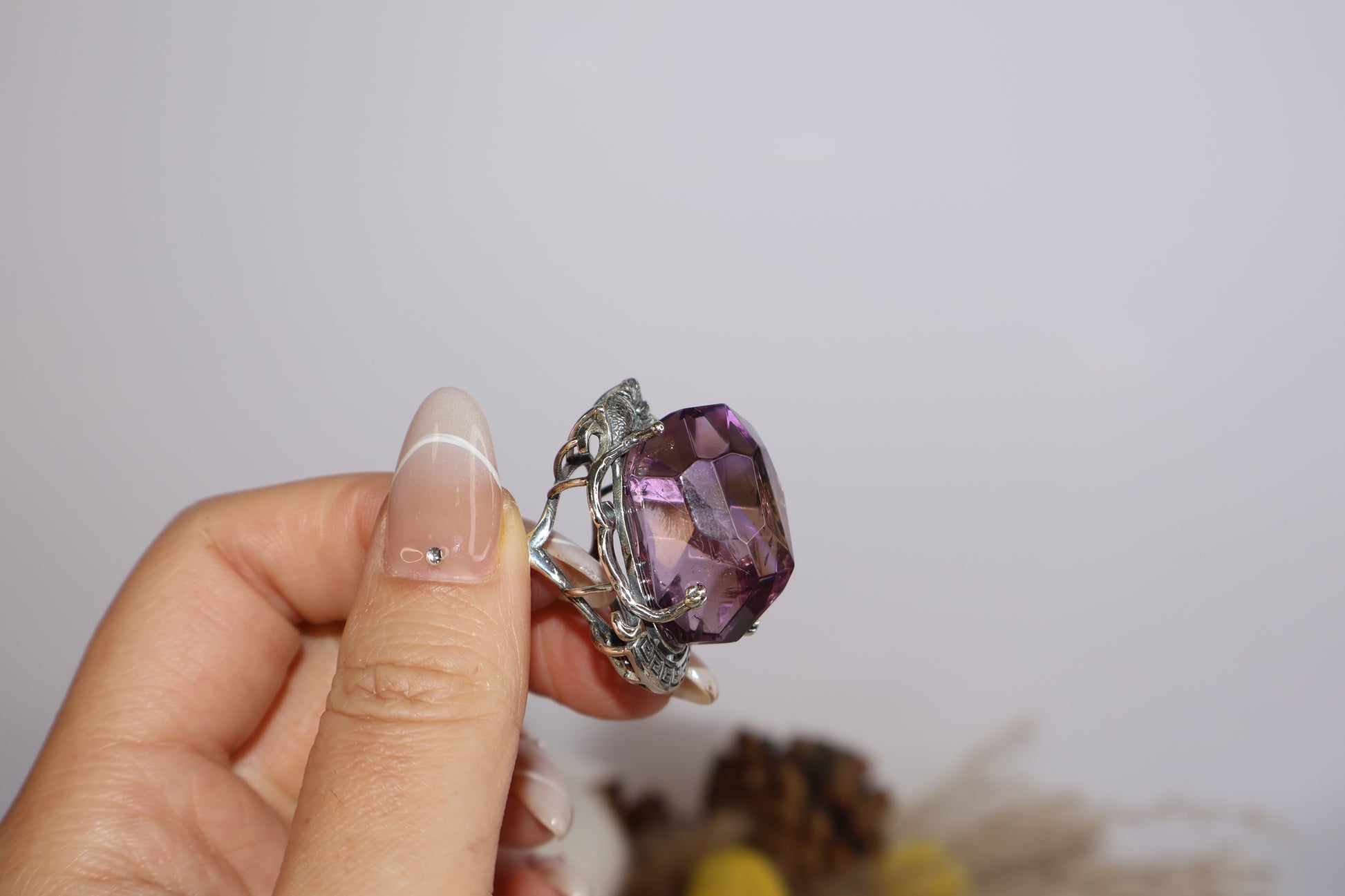 Side handheld view showing sculpted twin fish and crystal structure