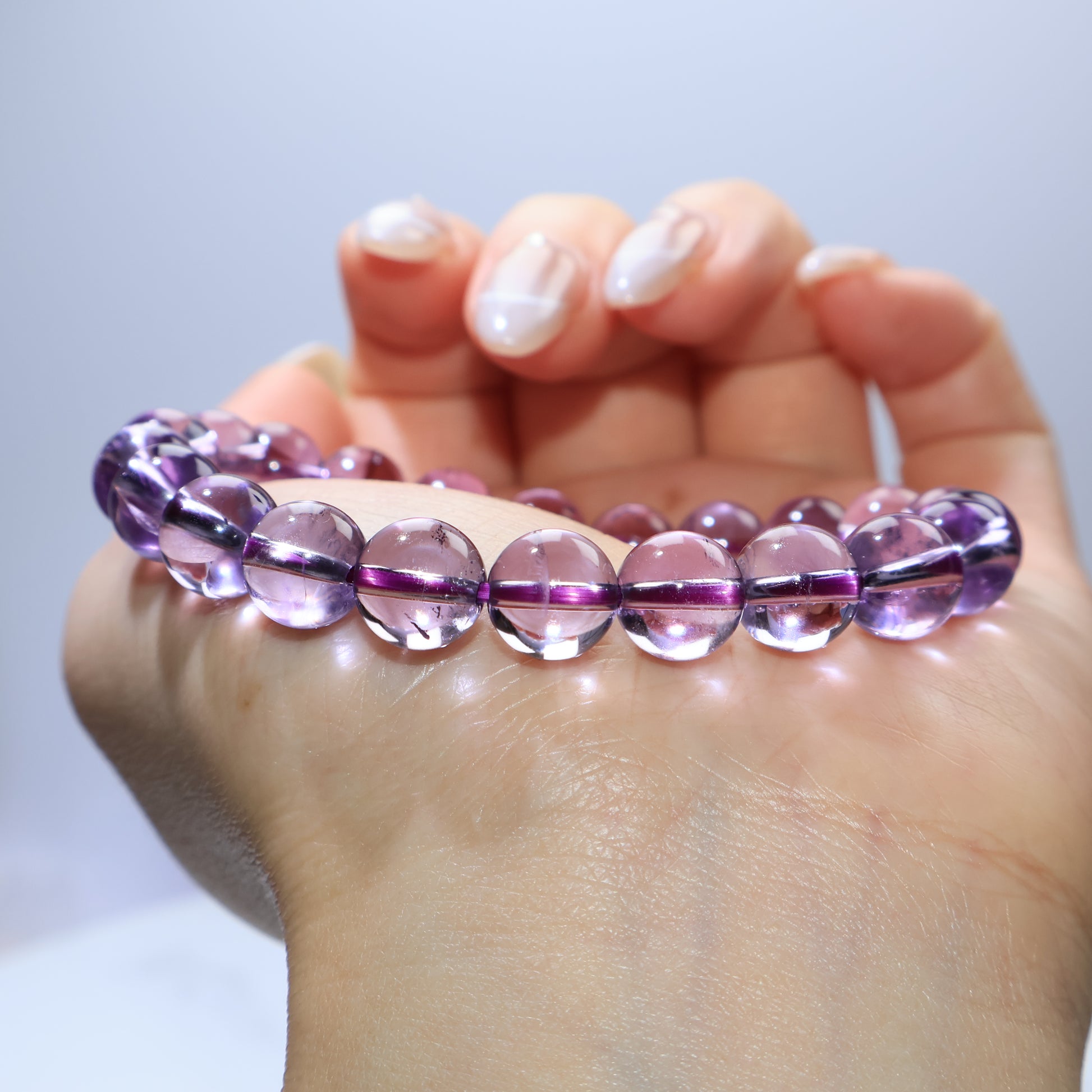Close-up wrist shot emphasizing the purity and luminosity of each bead