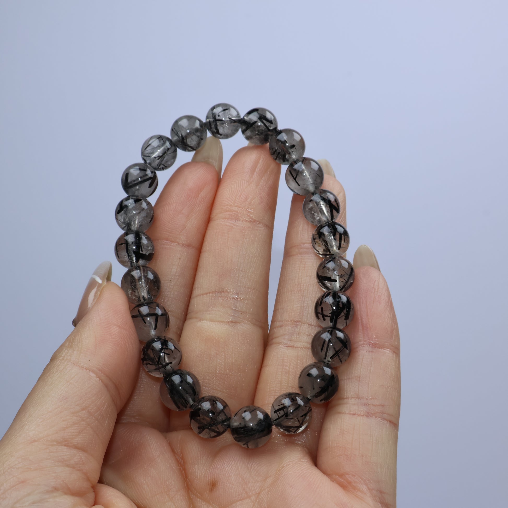 Handheld shot of the bracelet showing clear alignment of rutile threads