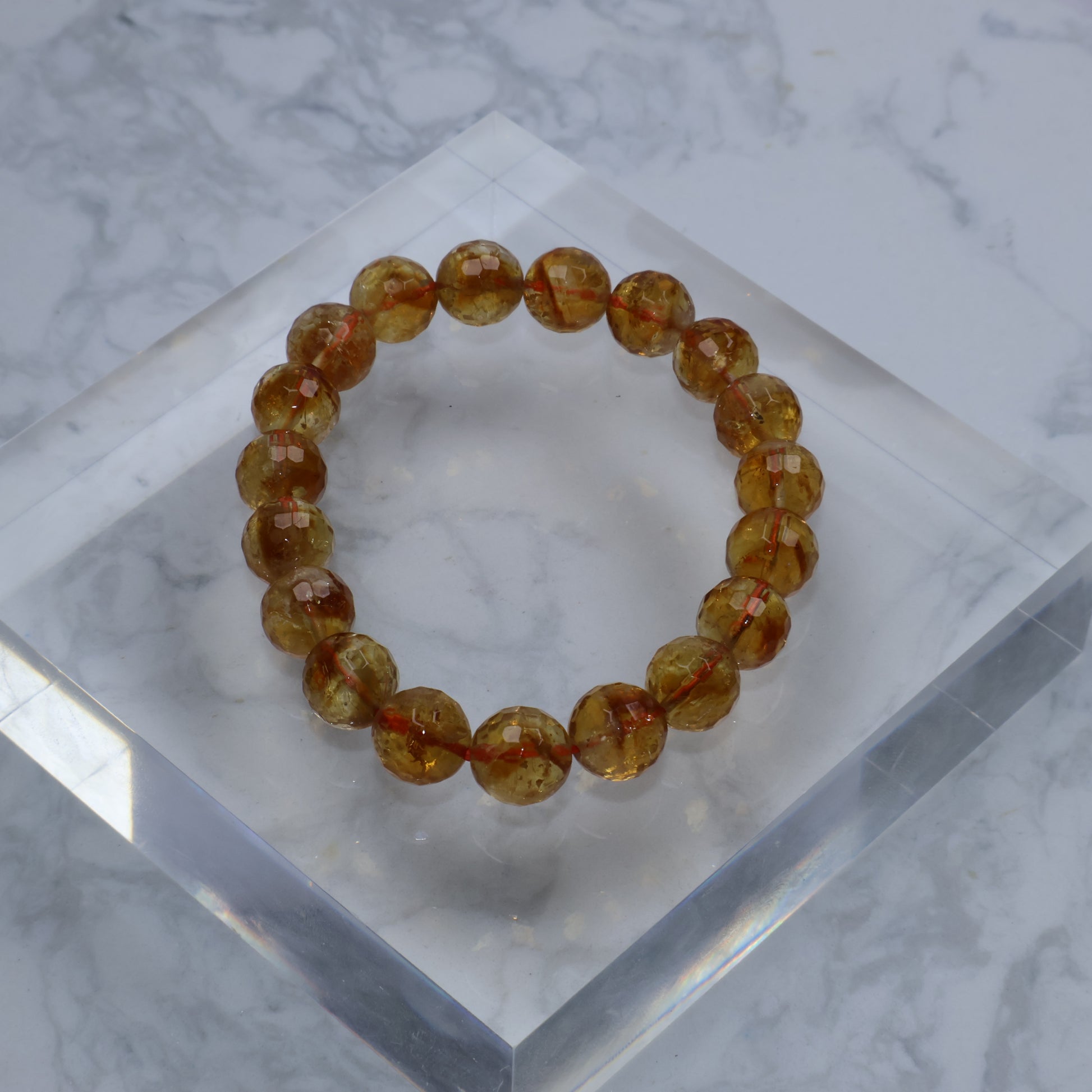 Full circle view of bracelet on clear acrylic block, highlighting symmetrical bead arrangement