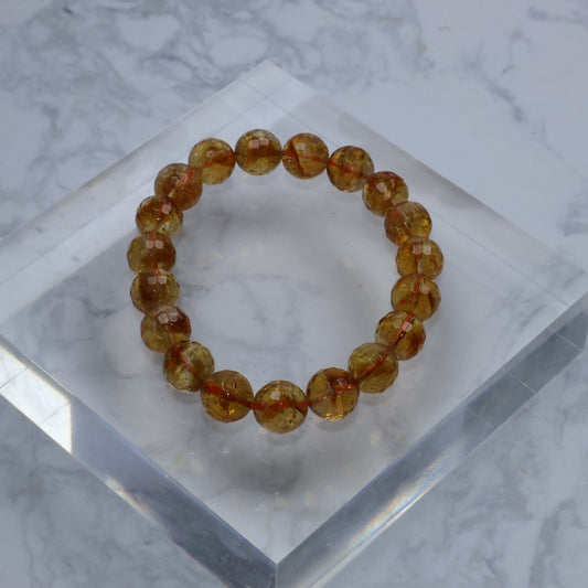 Full circle view of bracelet on clear acrylic block, highlighting symmetrical bead arrangement