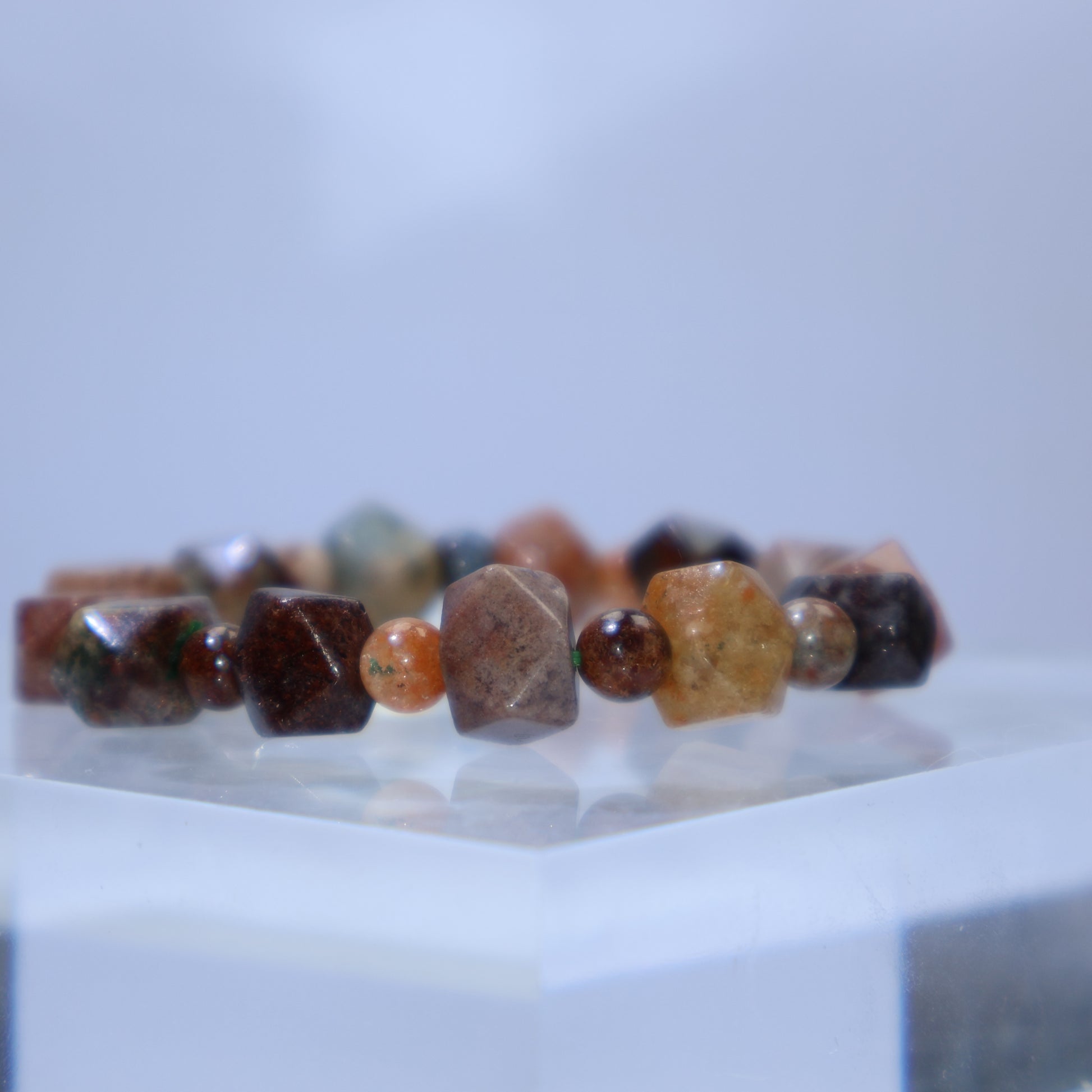 Close-up showing varied mineral inclusions in earthy greens, reds, and browns