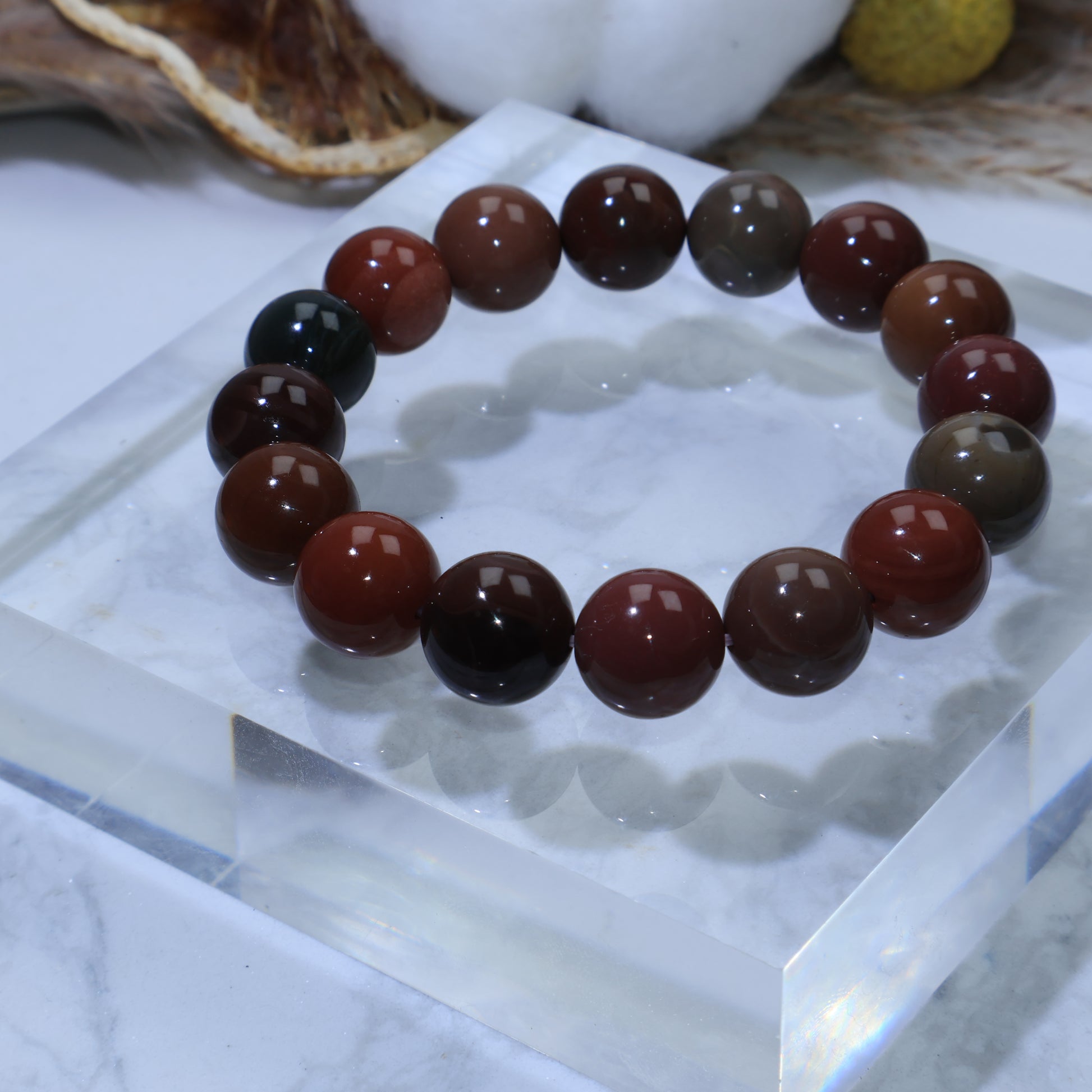 Overhead angle of Alxa Agate bracelet with cotton and dried orange background