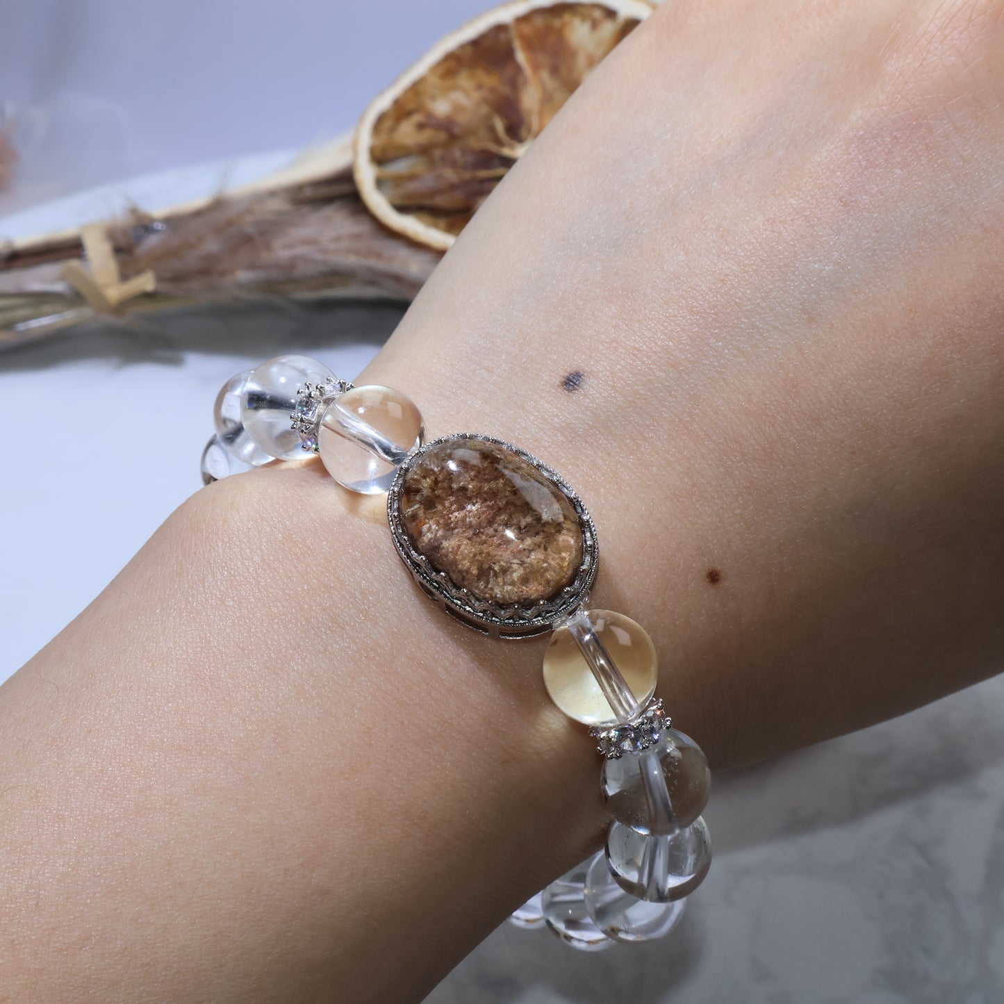 Phantom Quartz bracelet worn on wrist, highlighting the oval cabochon and sparkling cubic zirconia spacers