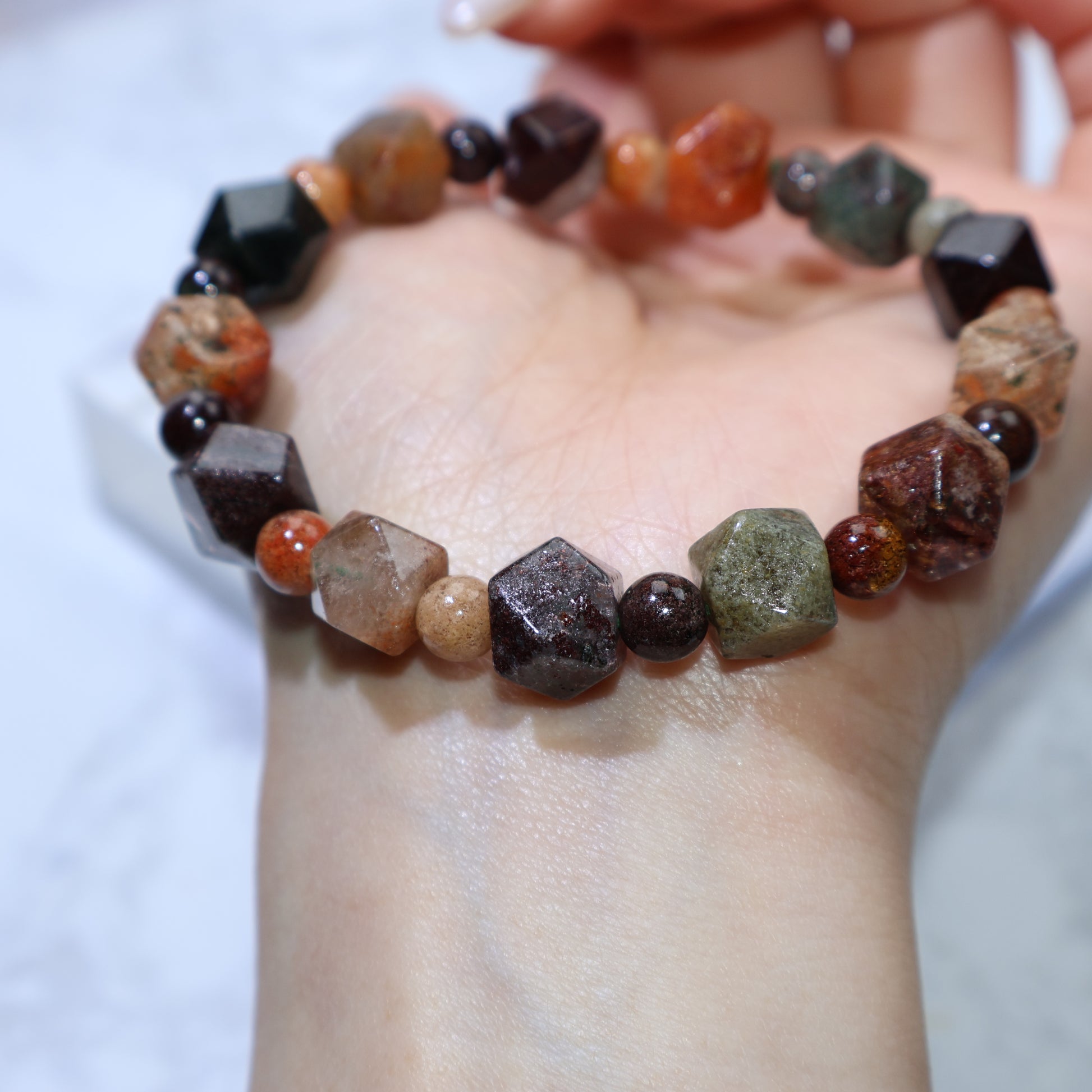 Bracelet resting on white background showing bead shape and size