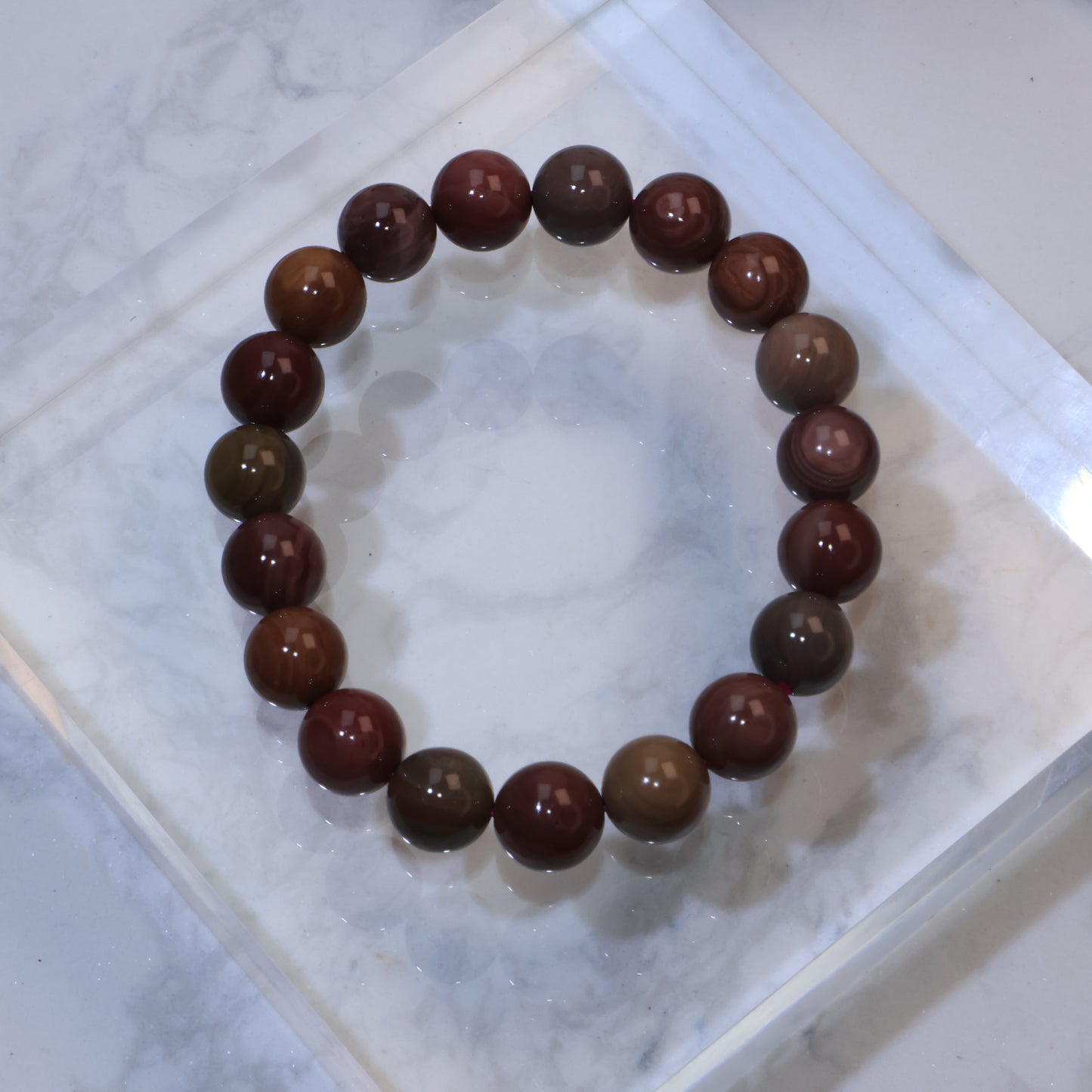 Top-down view of 10mm Mookaite Jasper bracelet showing natural earthy tones and patterns