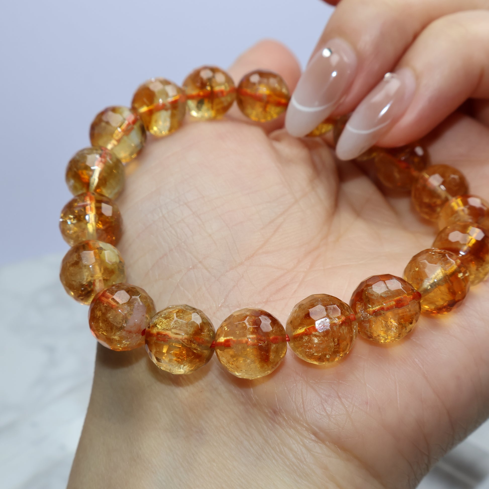 Close-up of citrine bracelet against hand, showing crystal clarity with some cloudiness