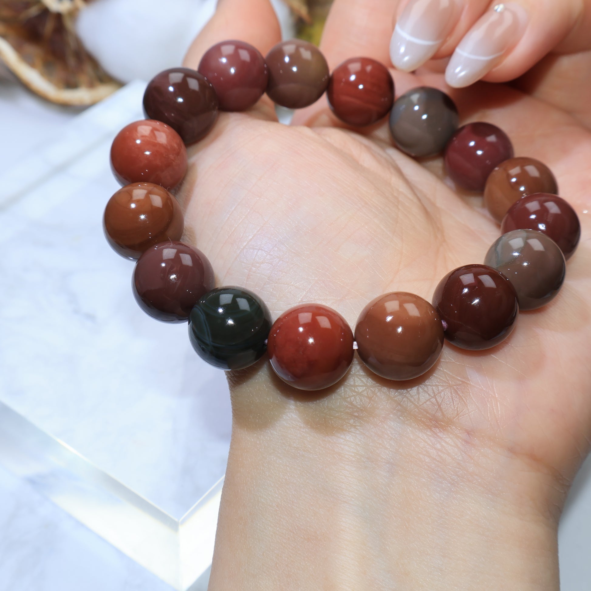 Bracelet resting across palm, highlighting natural patterns and mixed tones
