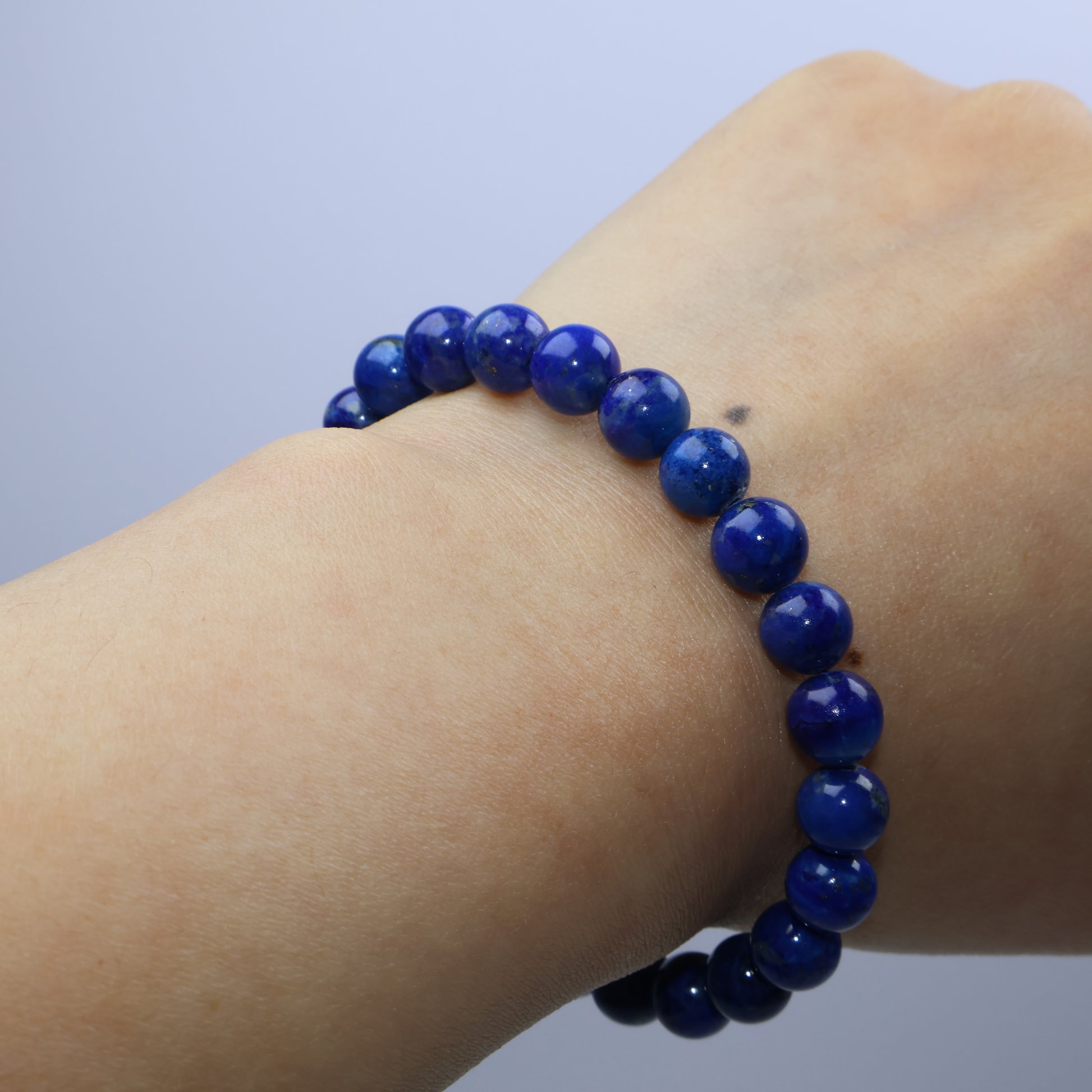 Wrist-wearing view of the 7mm lapis bracelet on a 15cm wrist