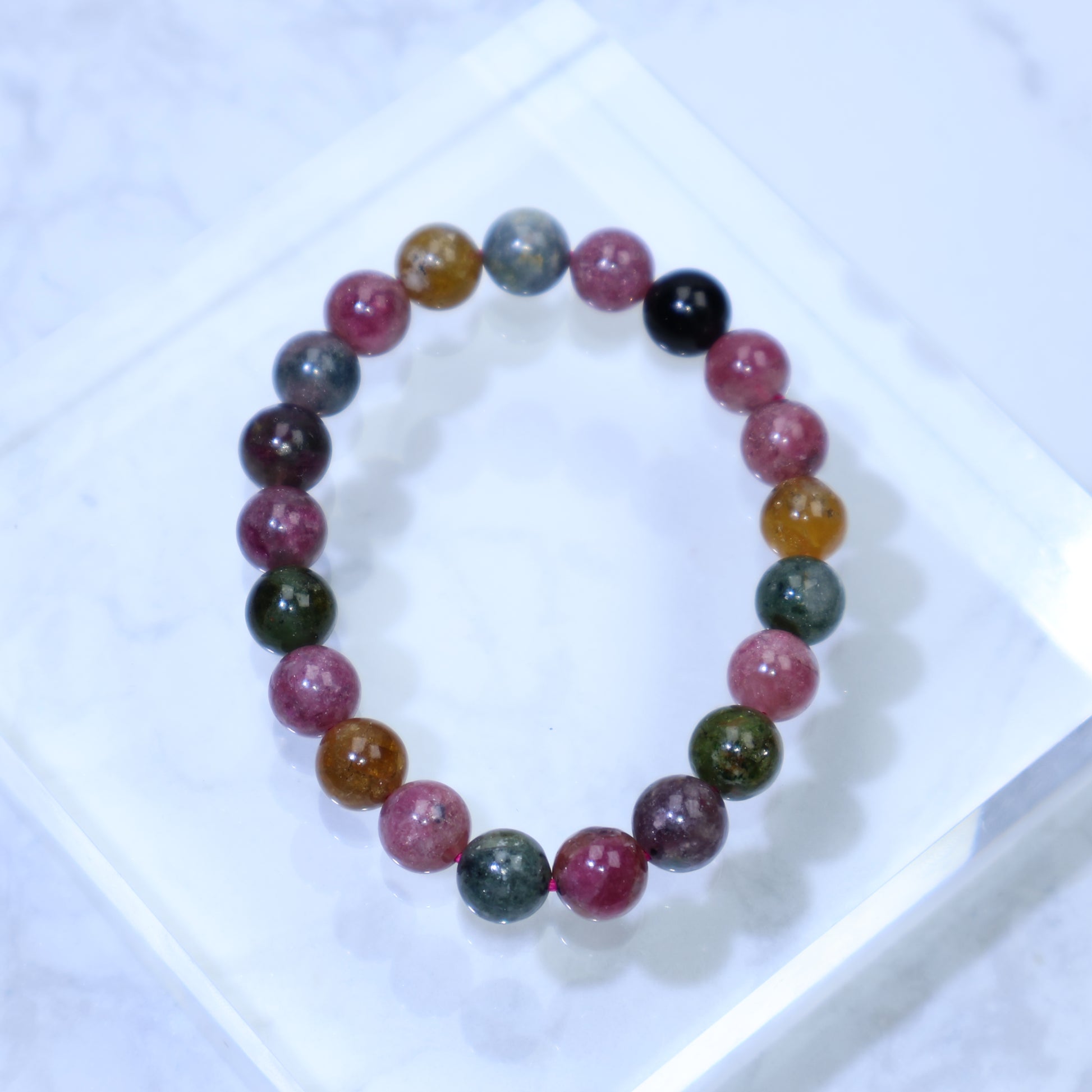 Top-down view of the bracelet in a circle formation on a marble surface