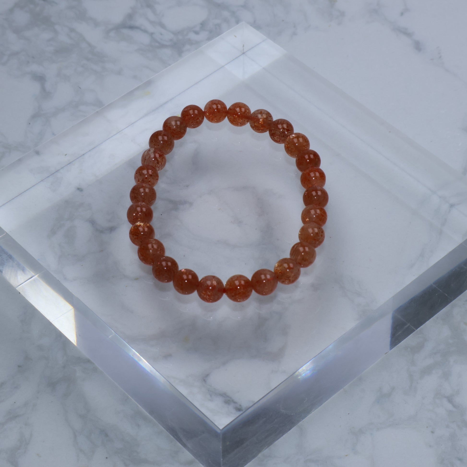 Top-down image of Sunstone bracelet on clear acrylic display