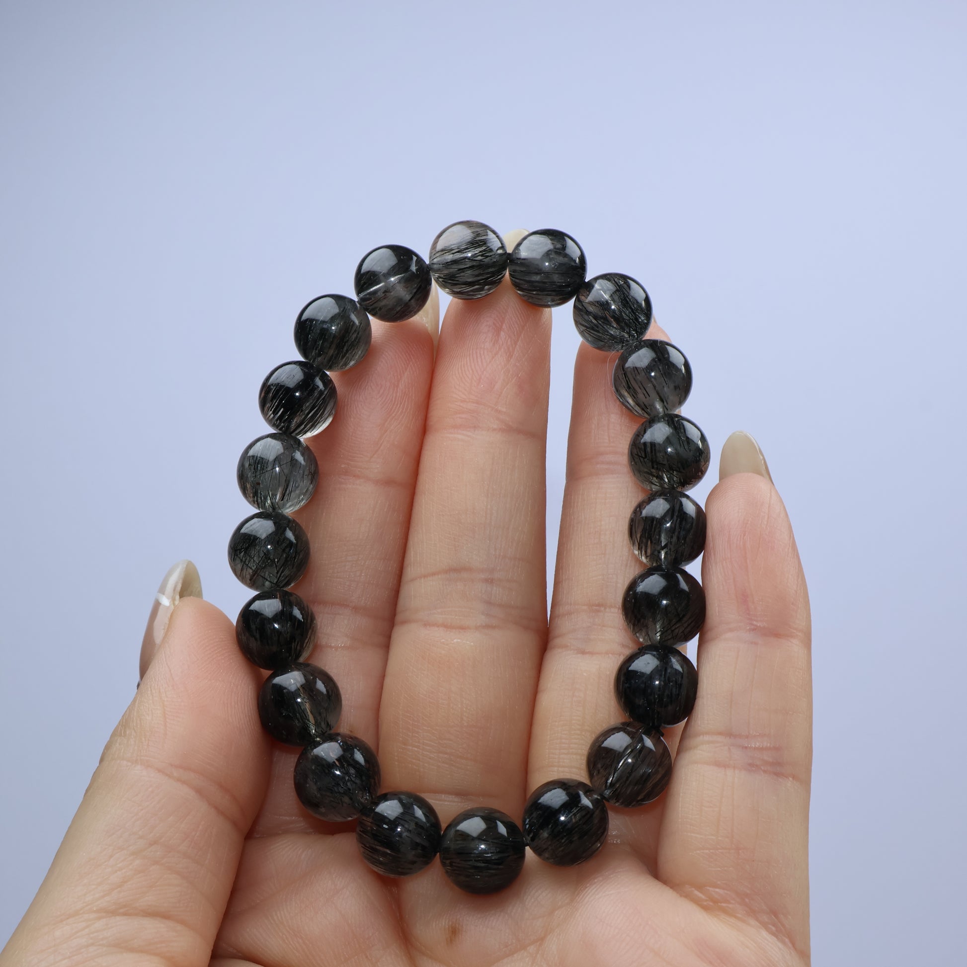 Handheld close-up view highlighting thread density and bead clarity