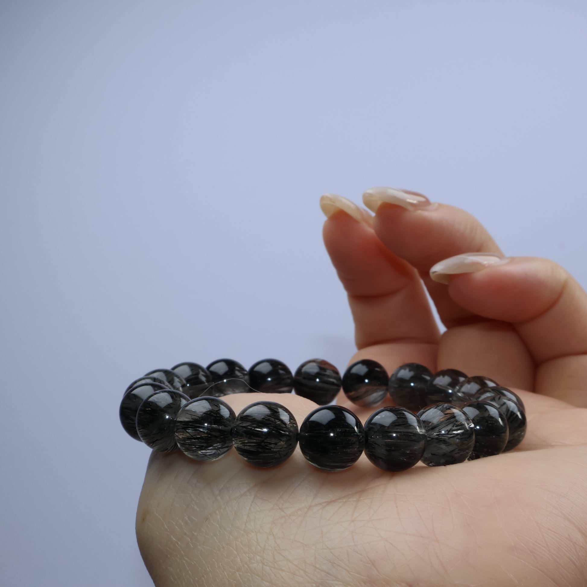 Fingertip hold showing bracelet curve and proportion in hand