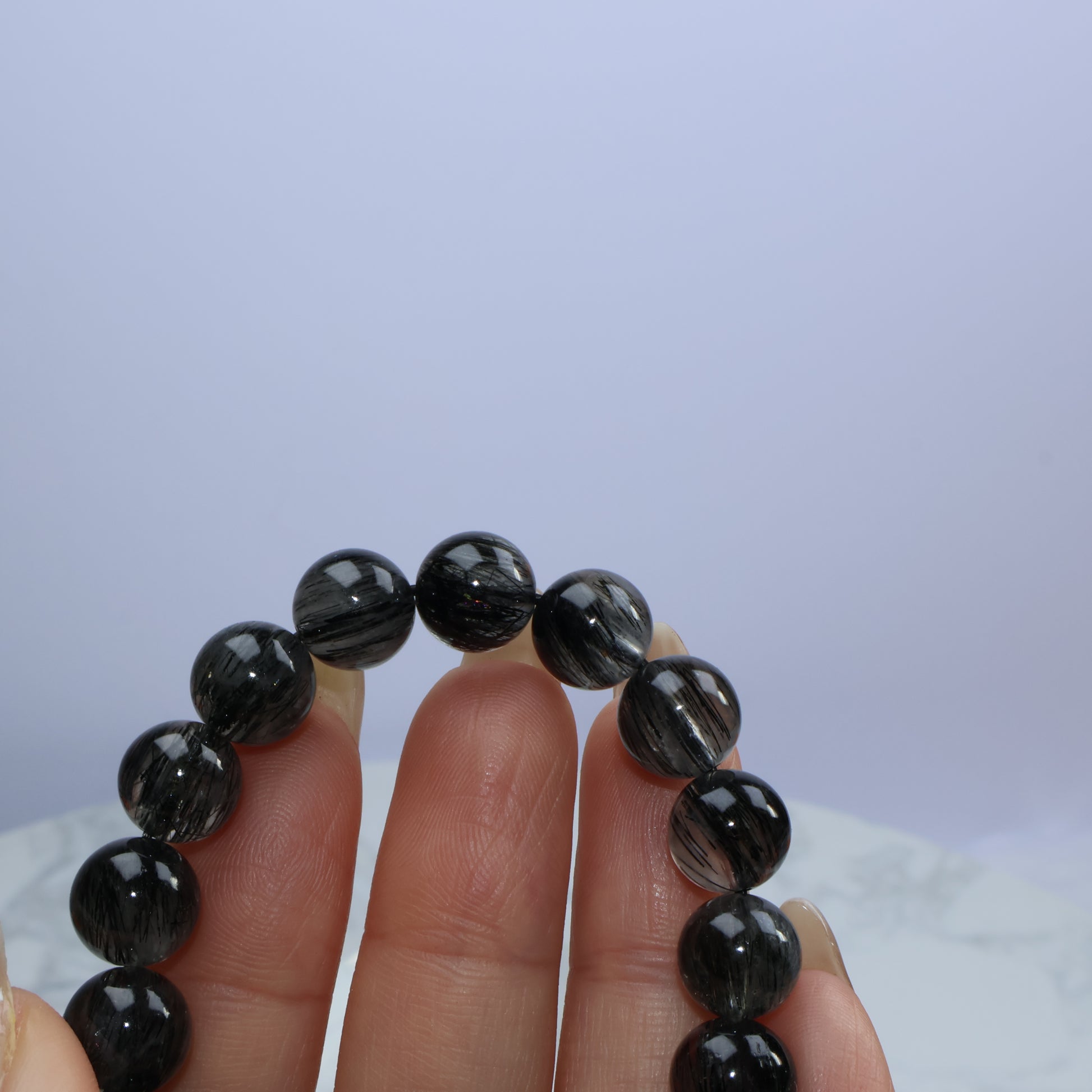 Close-up of Black Rutilated Quartz bracelet showing fine hair-like inclusions inside beads