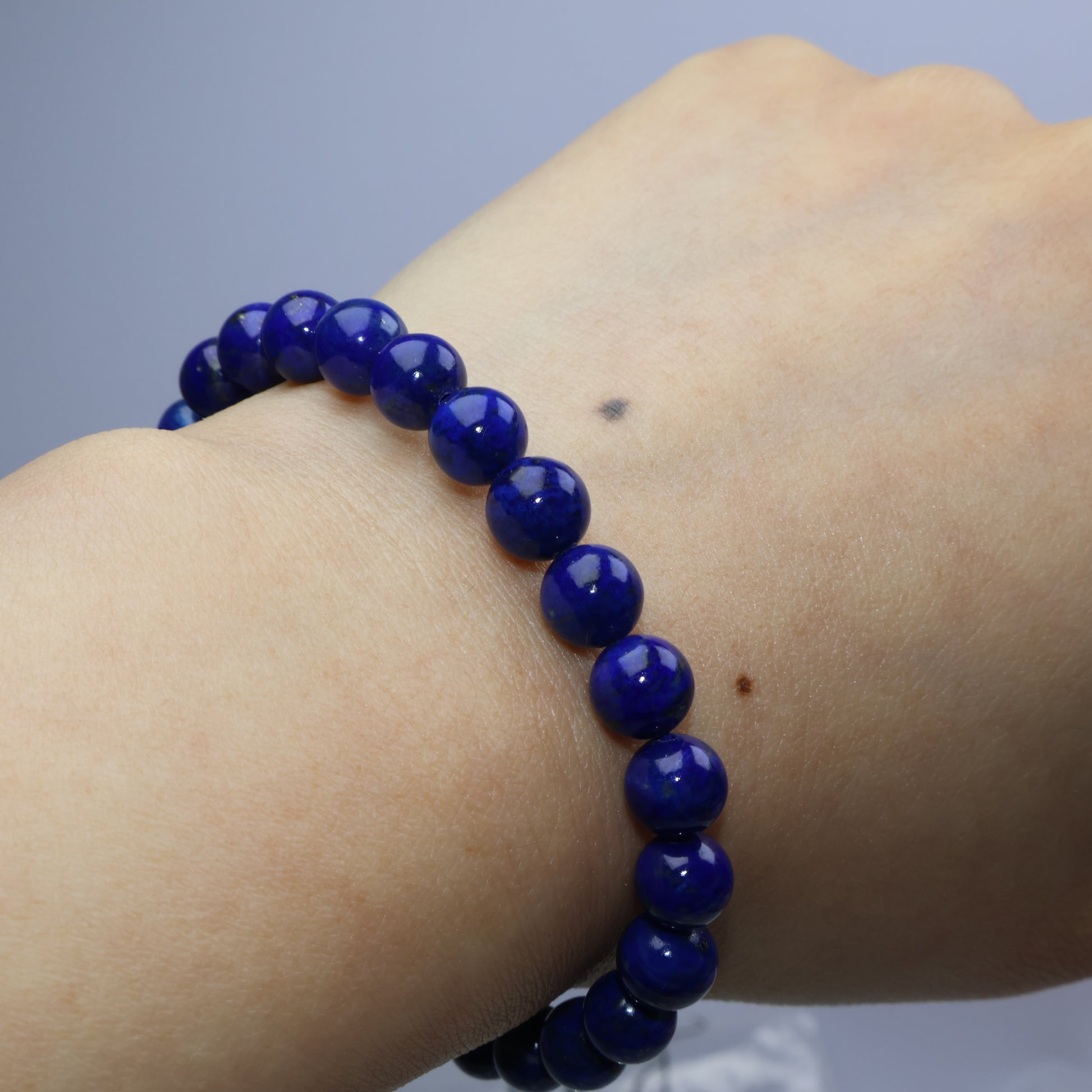 Wrist shot of Lapis Lazuli bracelet worn snugly on light skin