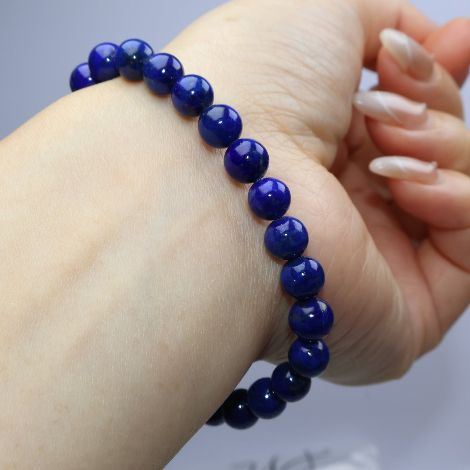 Natural pose showing bracelet draped across wrist and hand curl