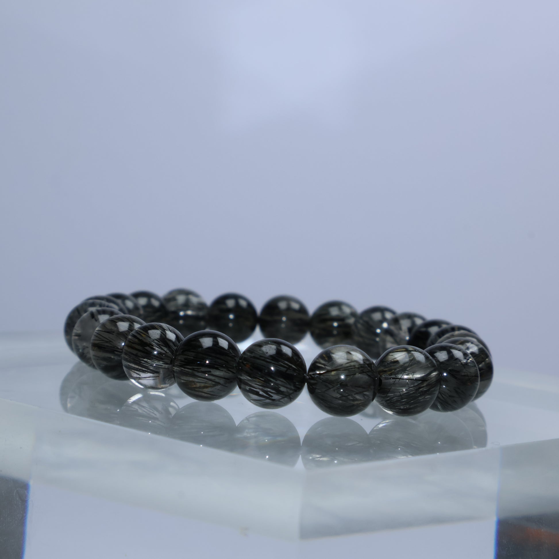 Side profile showcasing the lustrous and aligned rutiles within each bead