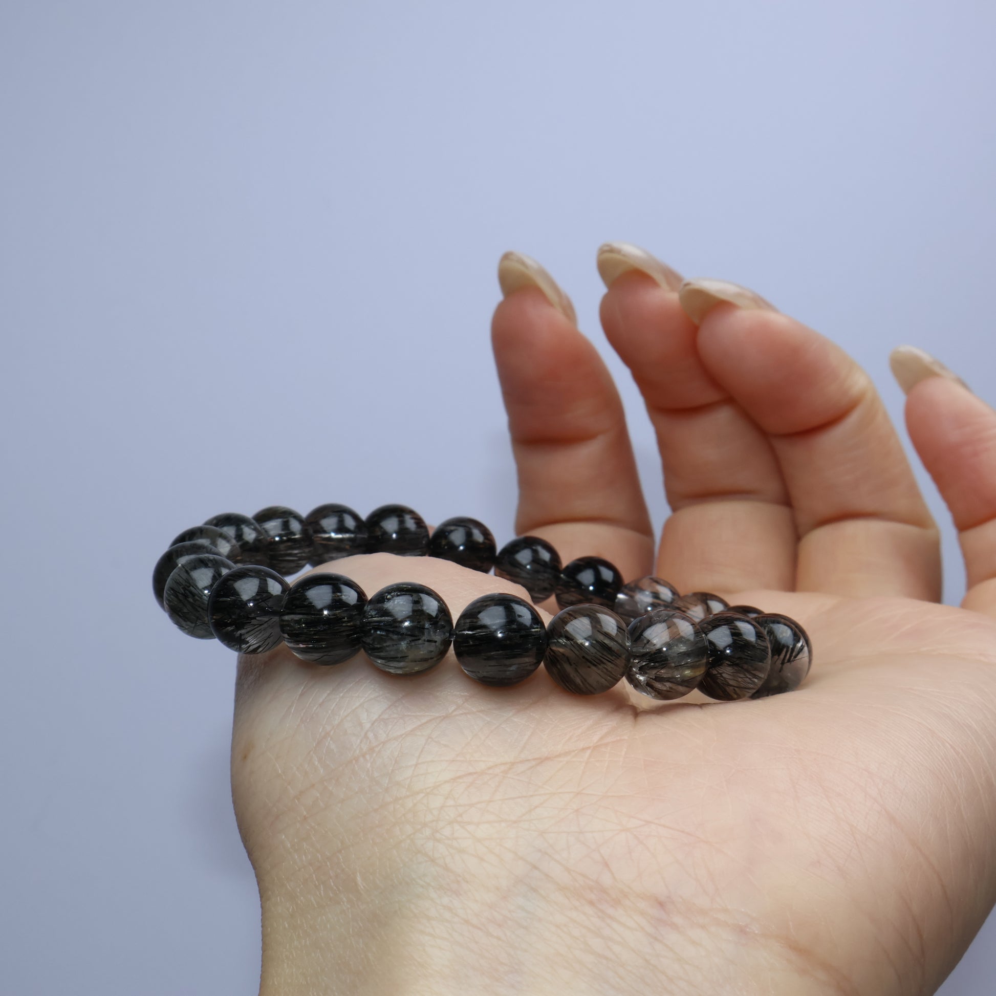 Bracelet draped across open palm to show clarity and structure