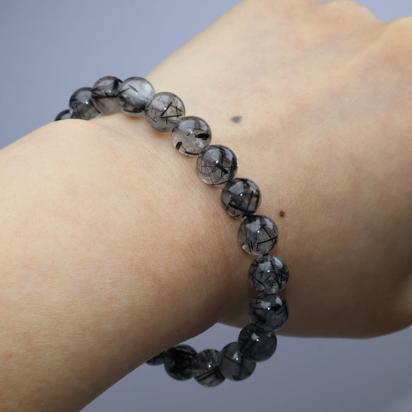 Worn on wrist – black rutiles within smoky quartz structure clearly displayed
