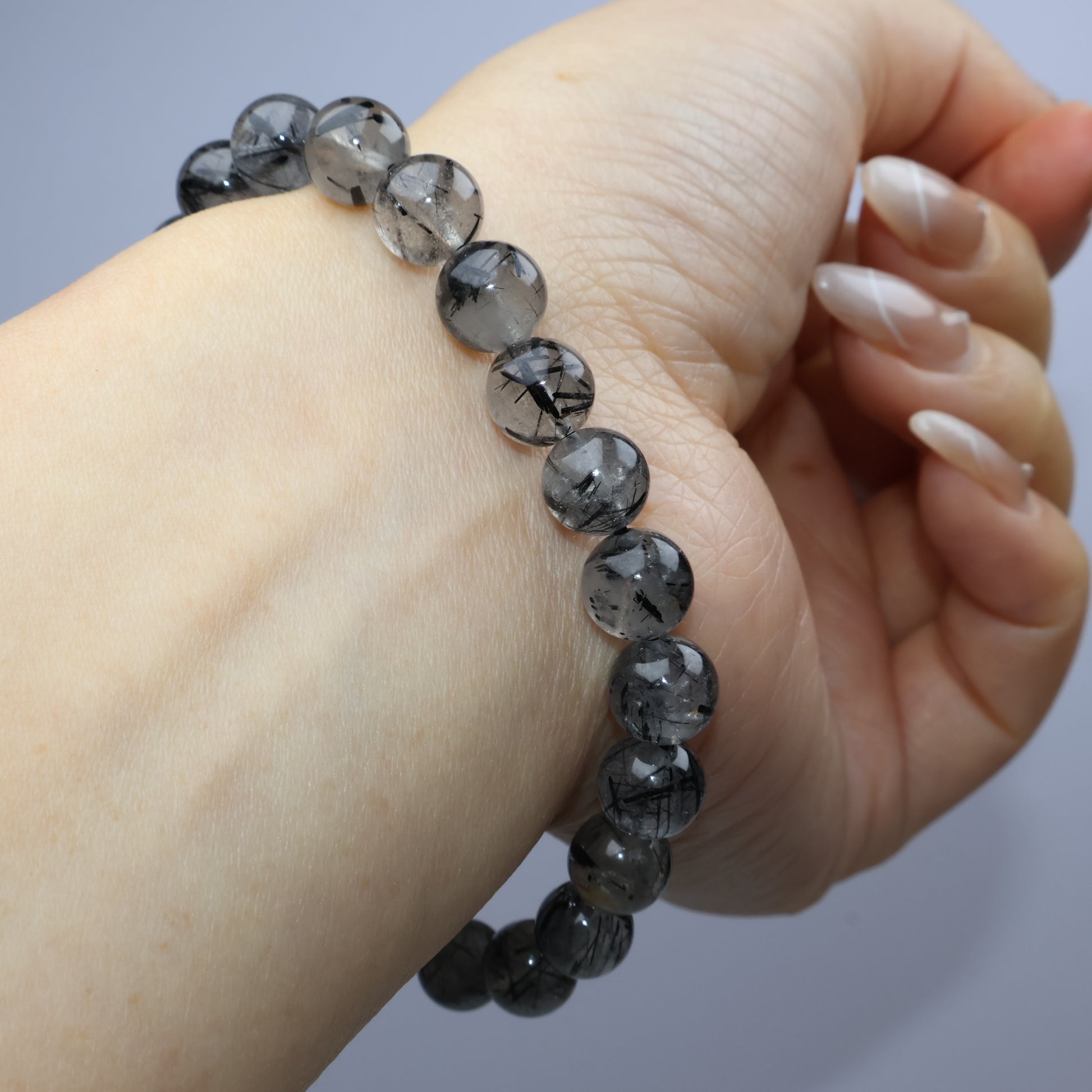 Wrist angle with curved bracelet to highlight shine and natural inclusions