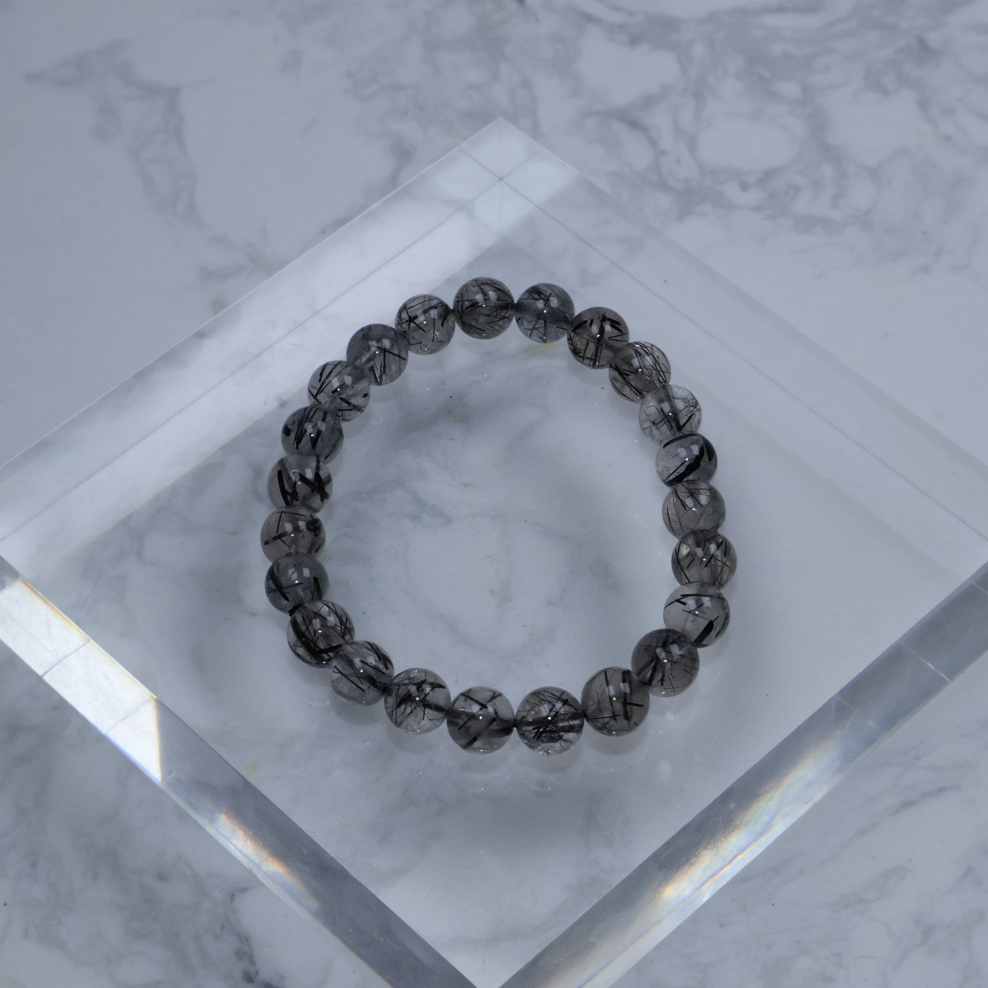 Top view of 7mm Black Rutilated Quartz bracelet arranged in a circle
