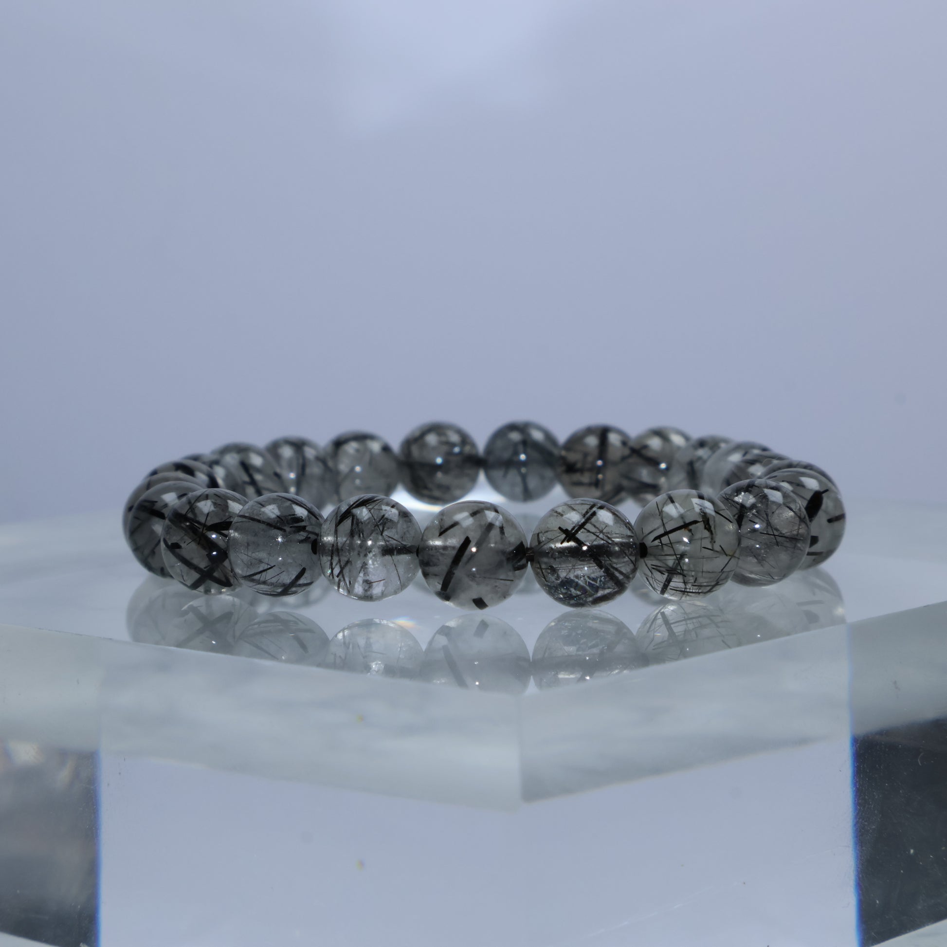 Side angle showing fine round beads with thick black rutile lines