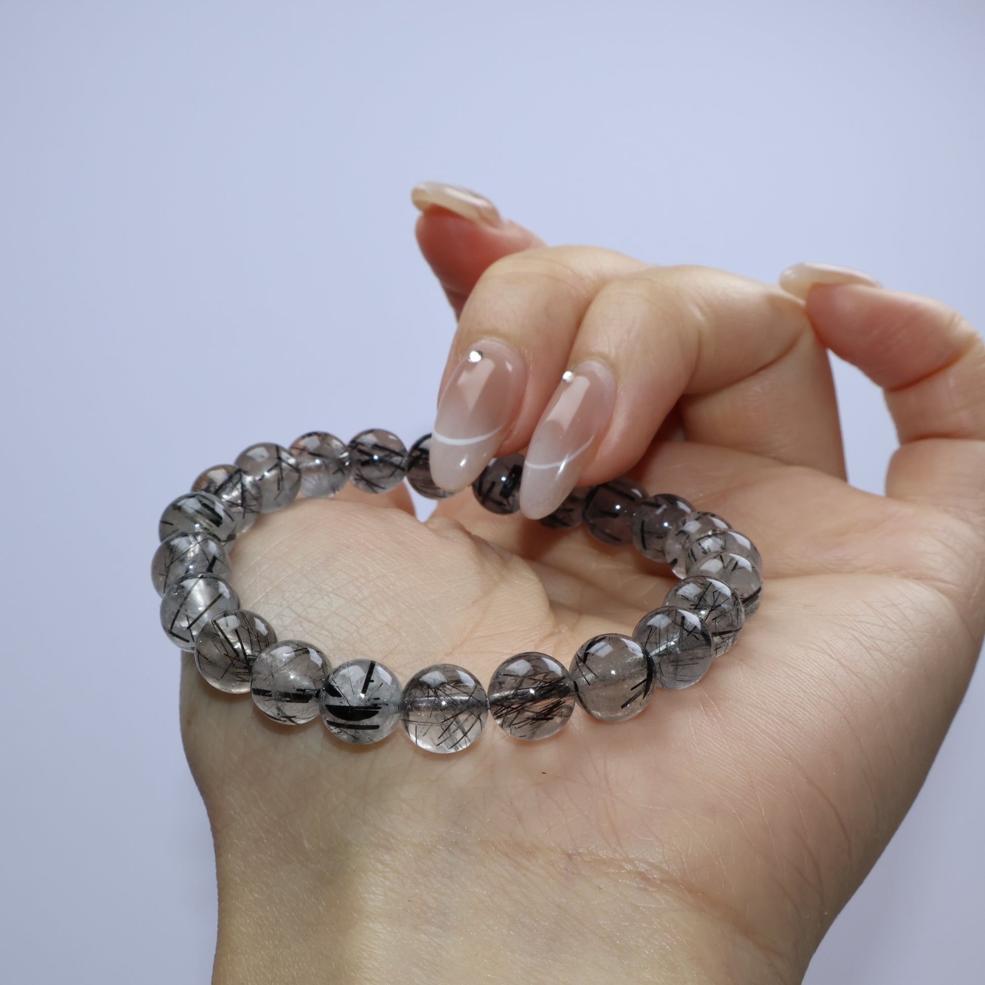 Close-up of smaller beads highlighting the contrast of rutile in quartz