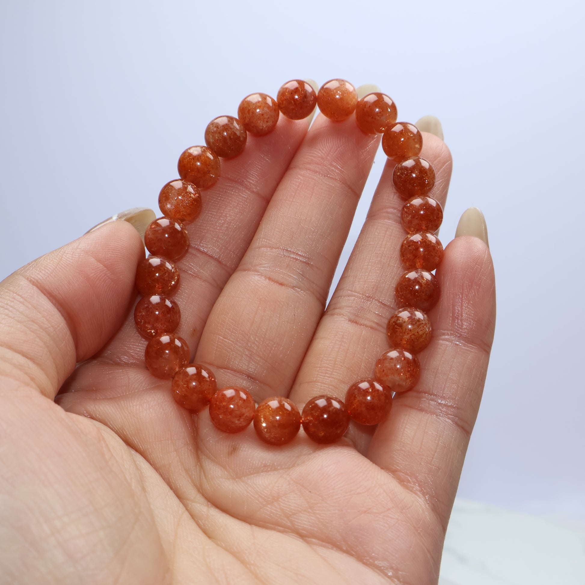 Handheld image highlighting bead quality and orange shimmer
