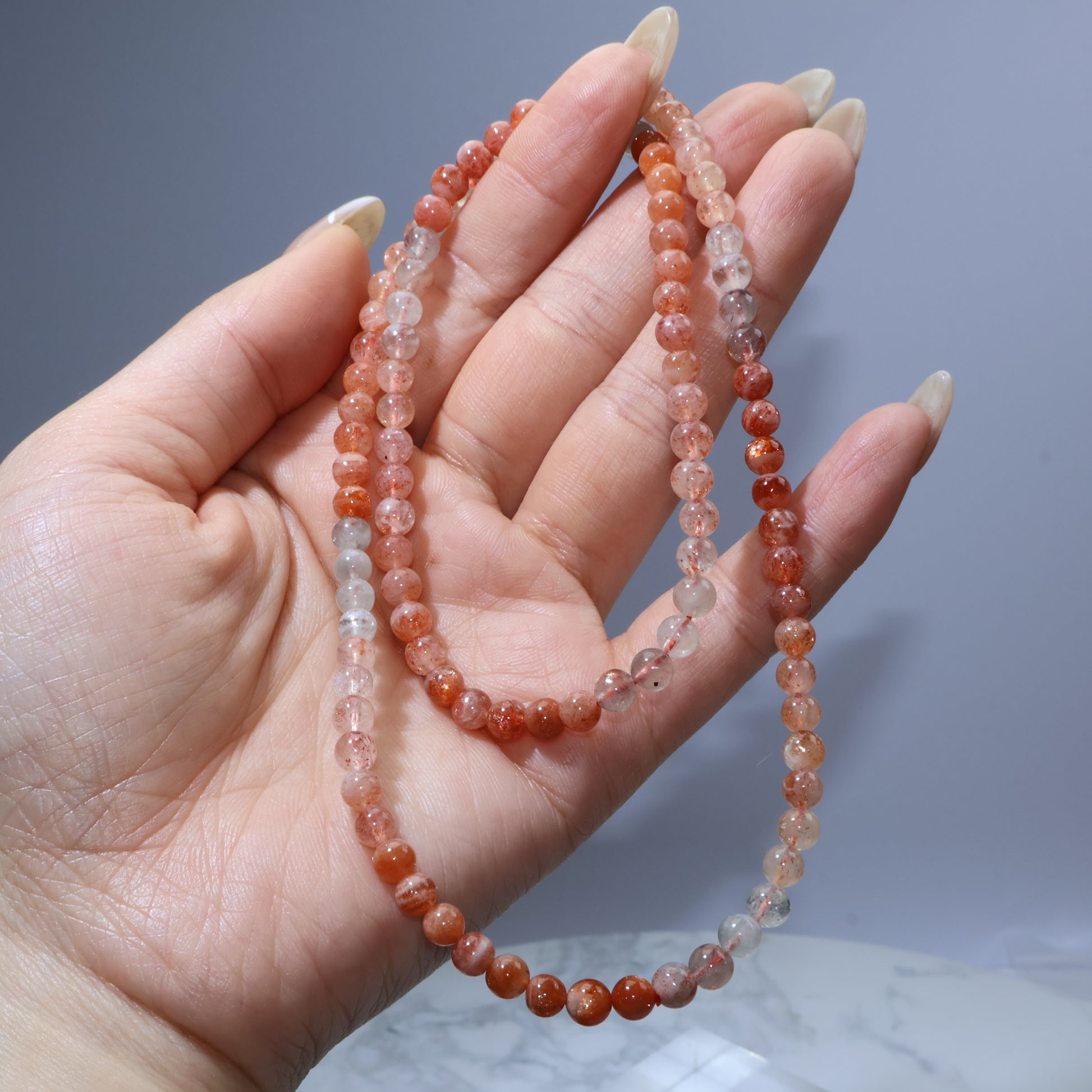 Full length view of bracelet in hand showing its triple wrap length