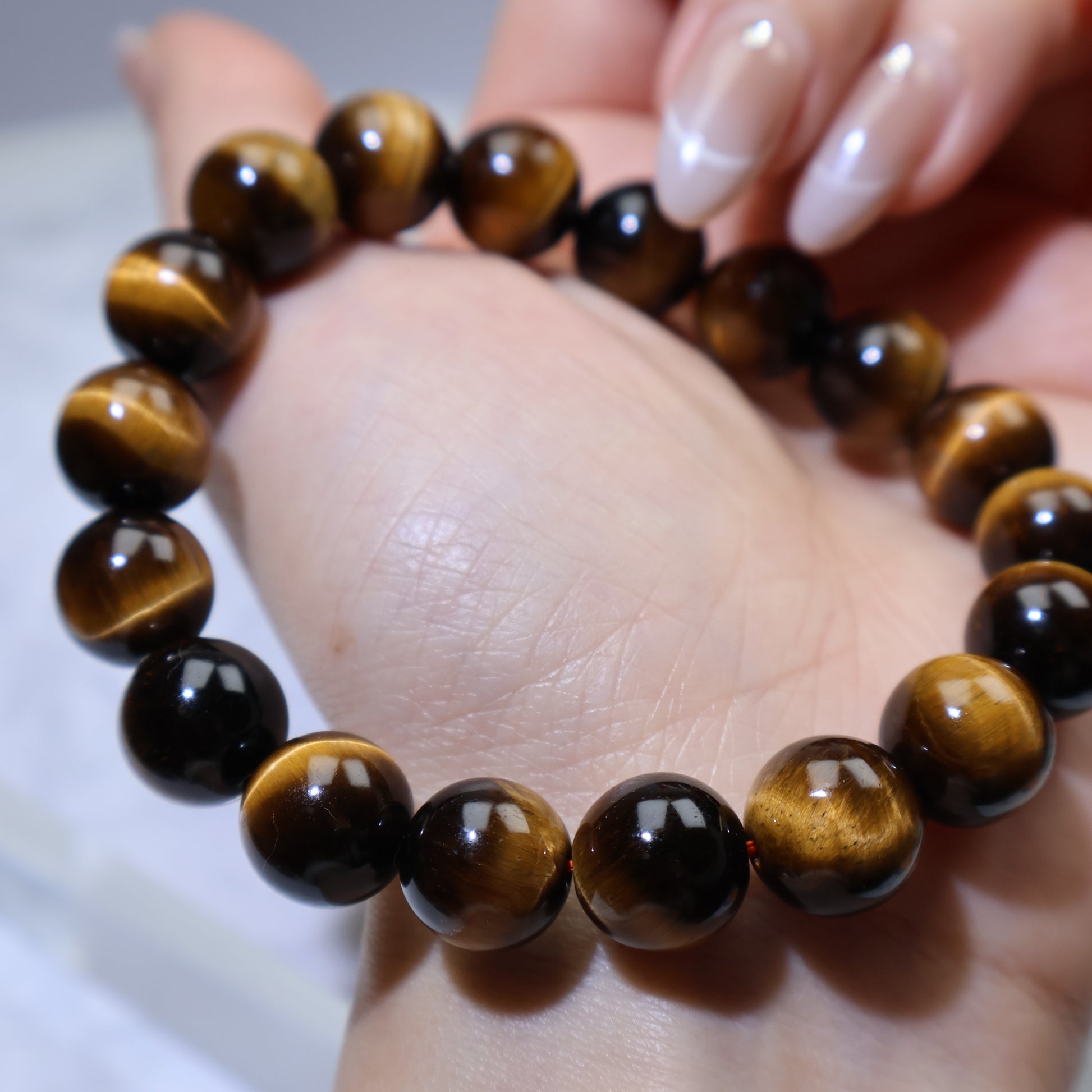 Close wrist shot with bracelet, displaying bead size and warm golden tones