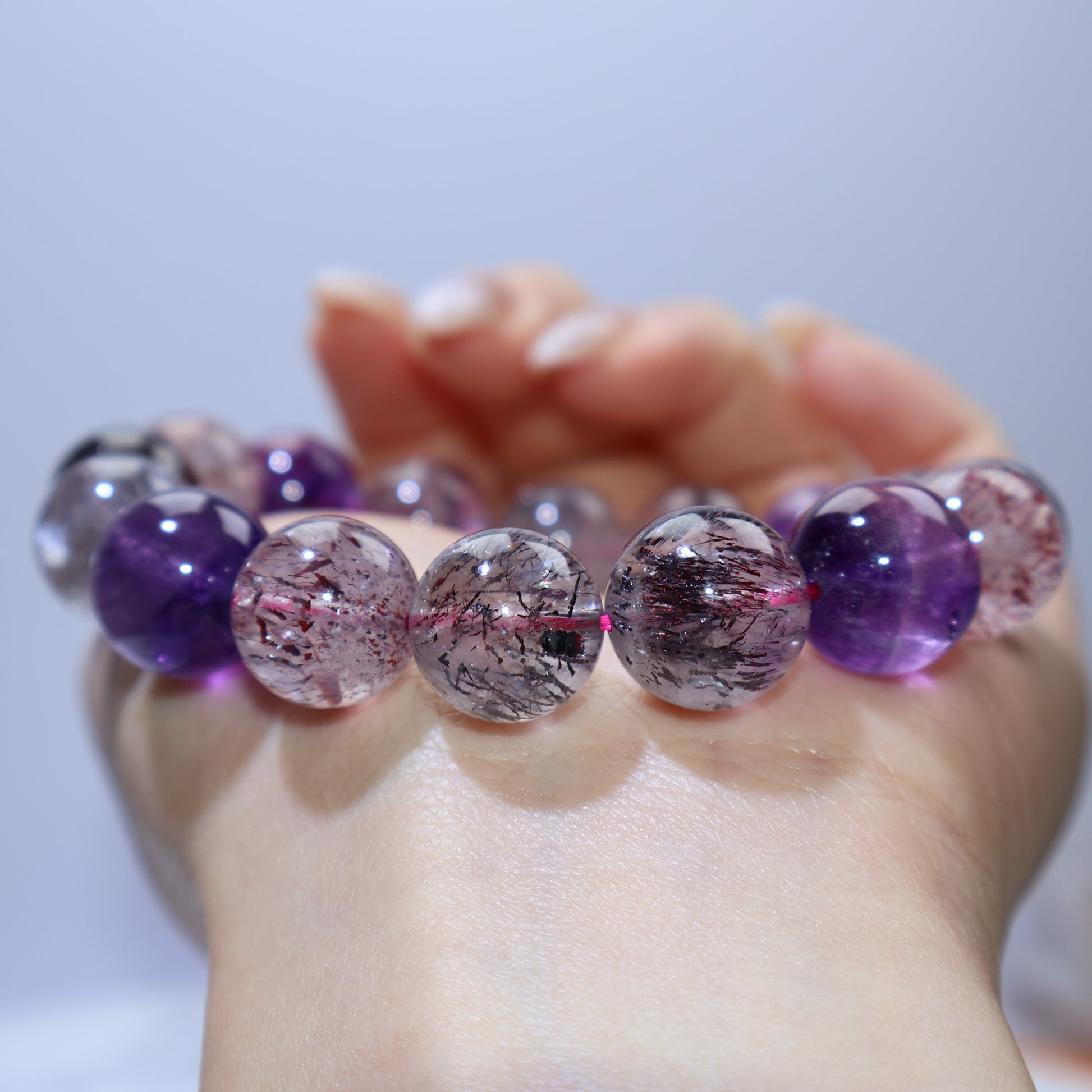 Close row view focusing on pink-red lepidocrocite clouds inside quartz