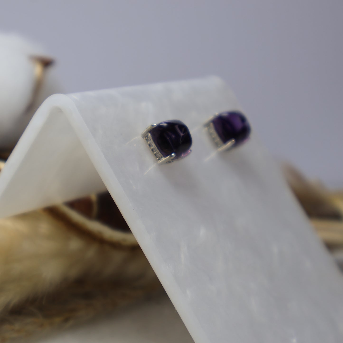 Close-up of natural 7mm amethyst stud earrings