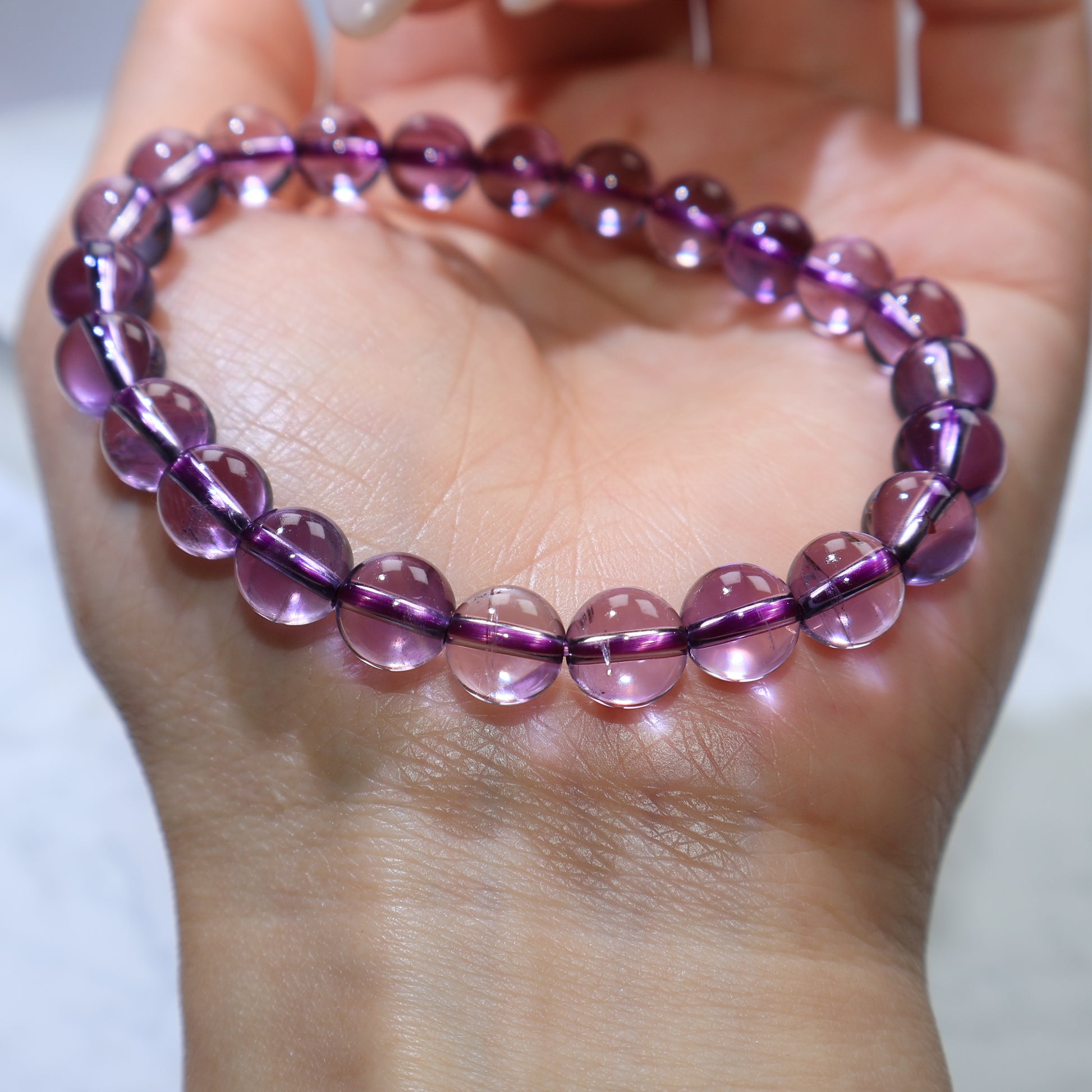 Close-up wrist shot emphasizing the purity and gentle color of each bead