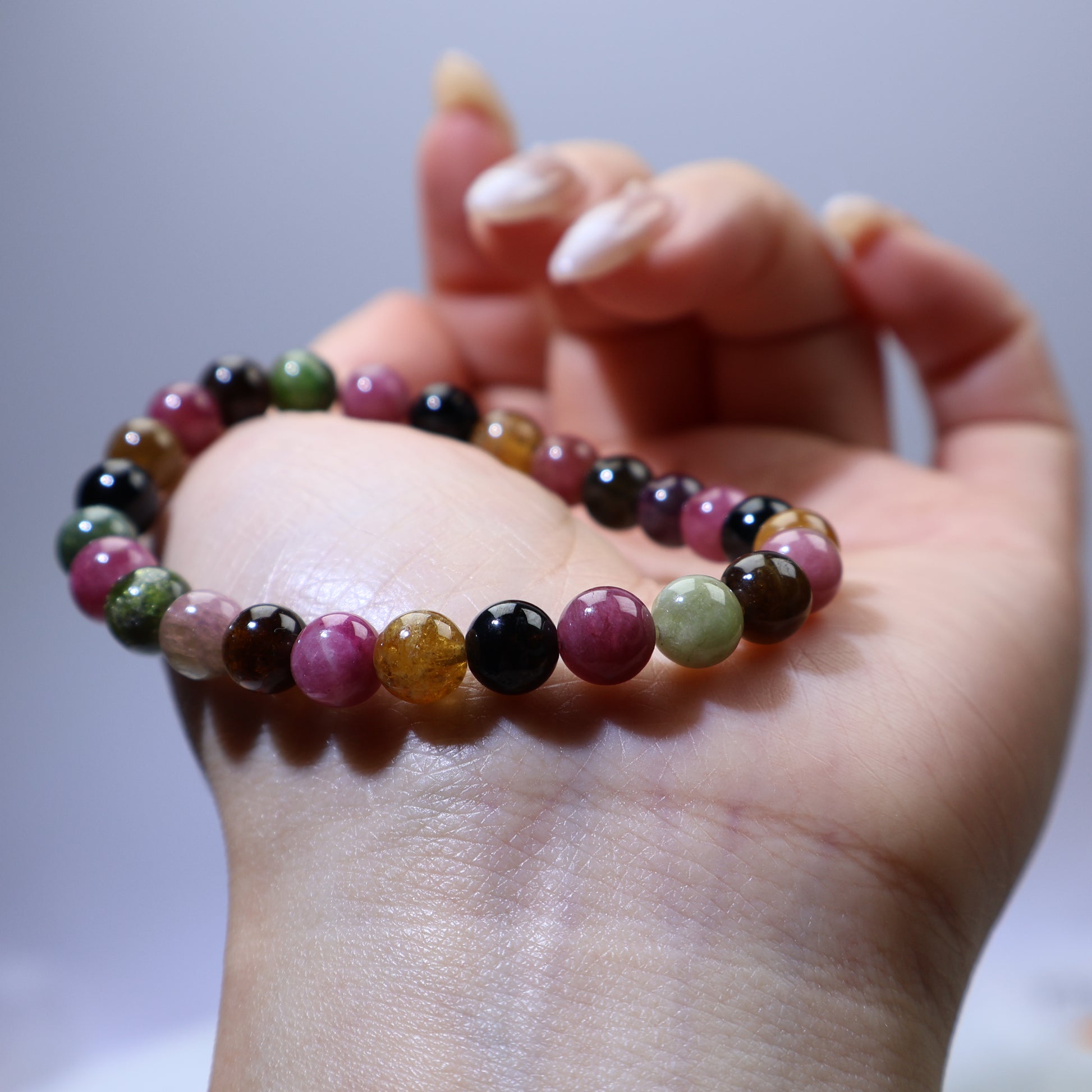 Close-up wrist shot highlighting the richness of each tourmaline color