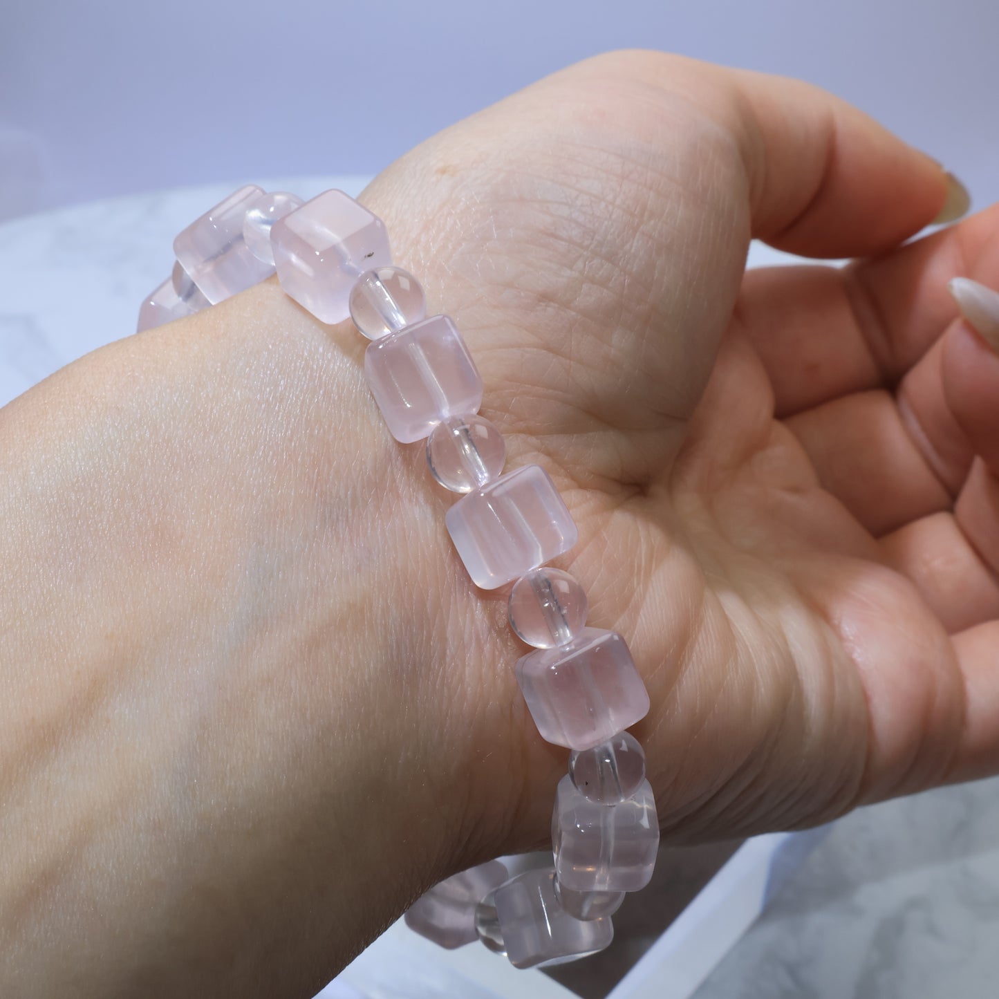 Reverse wrist view of Rose Quartz bracelet highlighting its soft romantic hue.