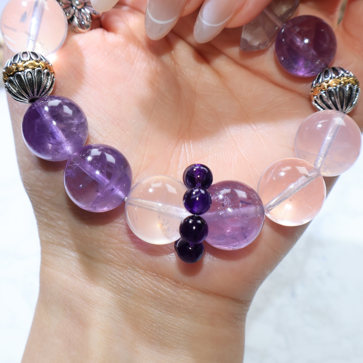 Focus on the tiny Uruguayan amethyst bead cluster bridging between a rose quartz and an amethyst bead.