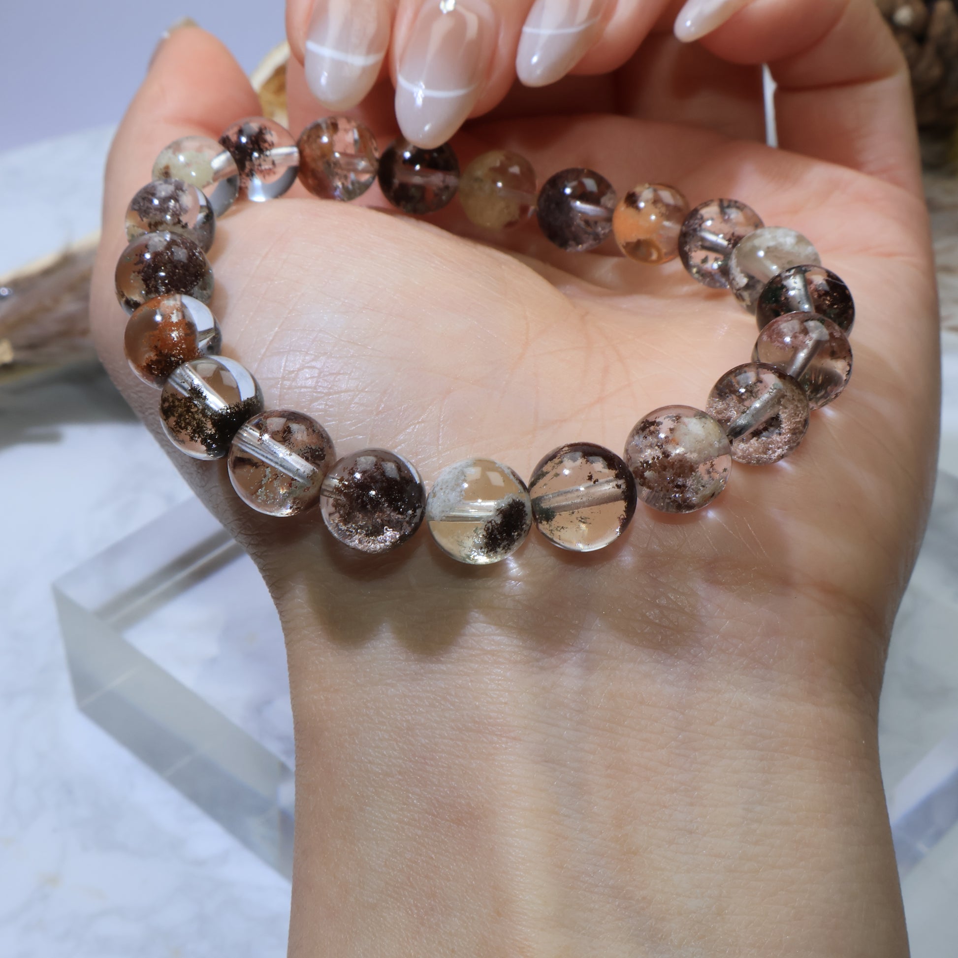 Close-up wrist angle of Scenic Phantom Quartz bracelet under natural lighting