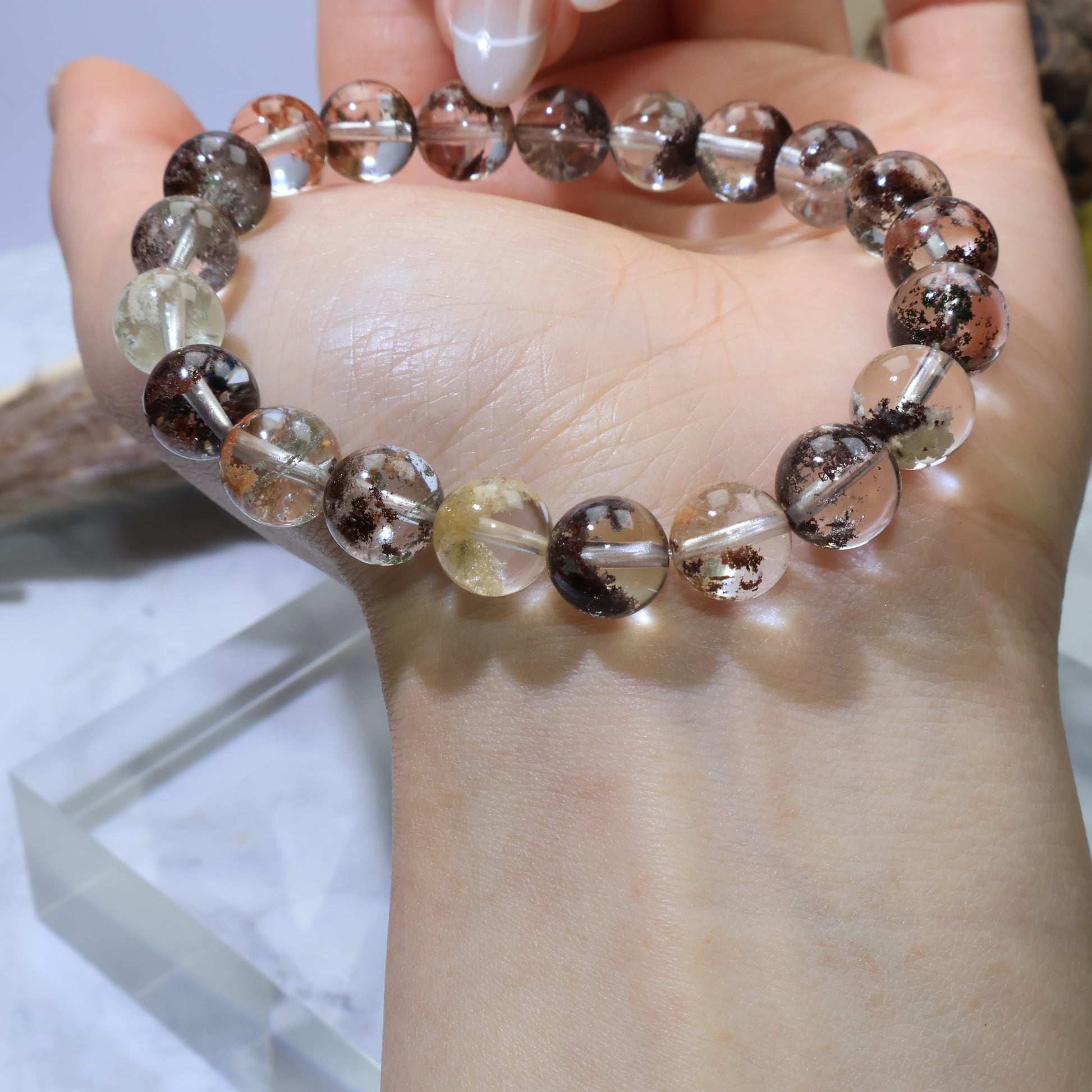 Wrist view showing full loop of Scenic Phantom Quartz bracelet with balanced bead arrangement