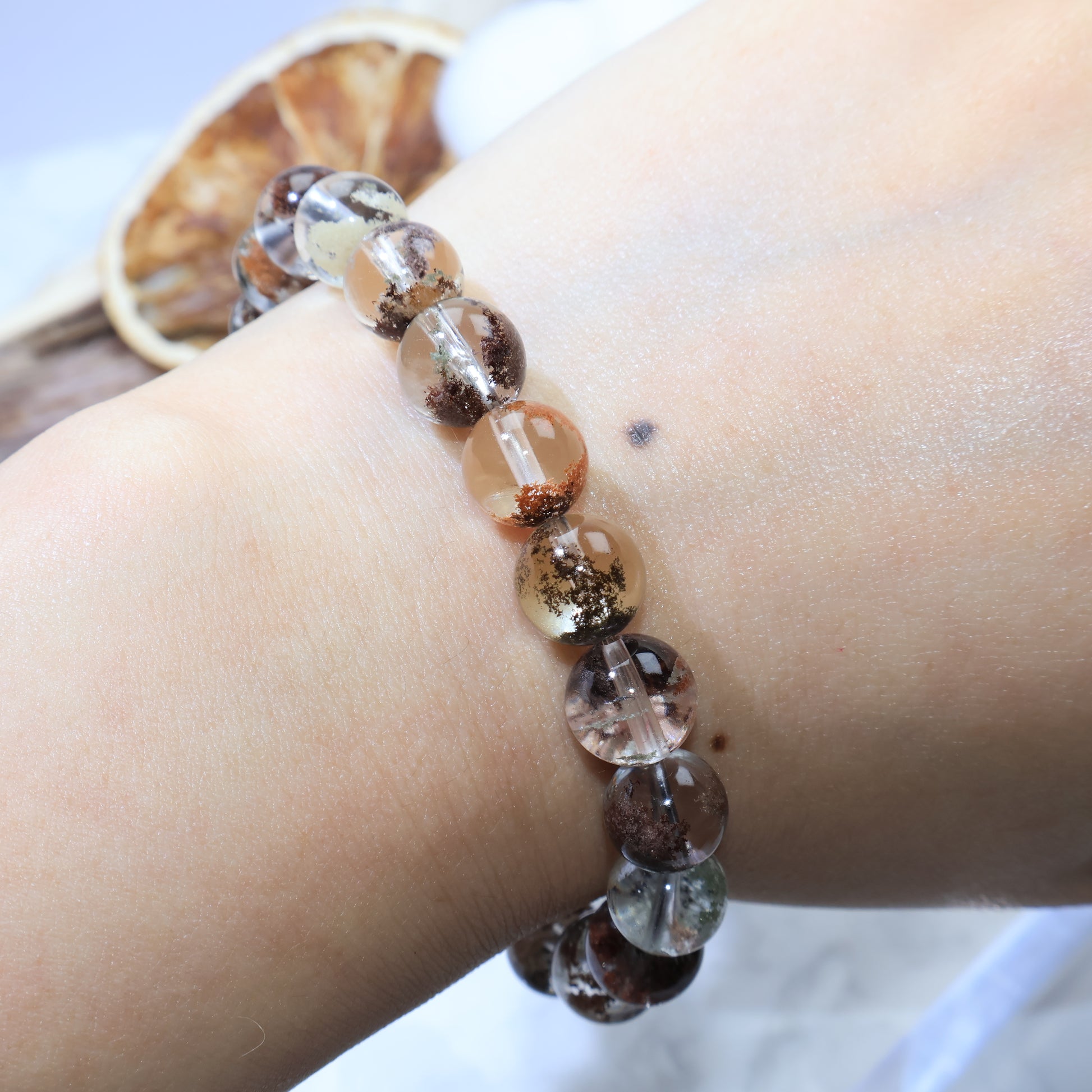 Macro close-up of Scenic Phantom Quartz bead with orange phantom inclusion