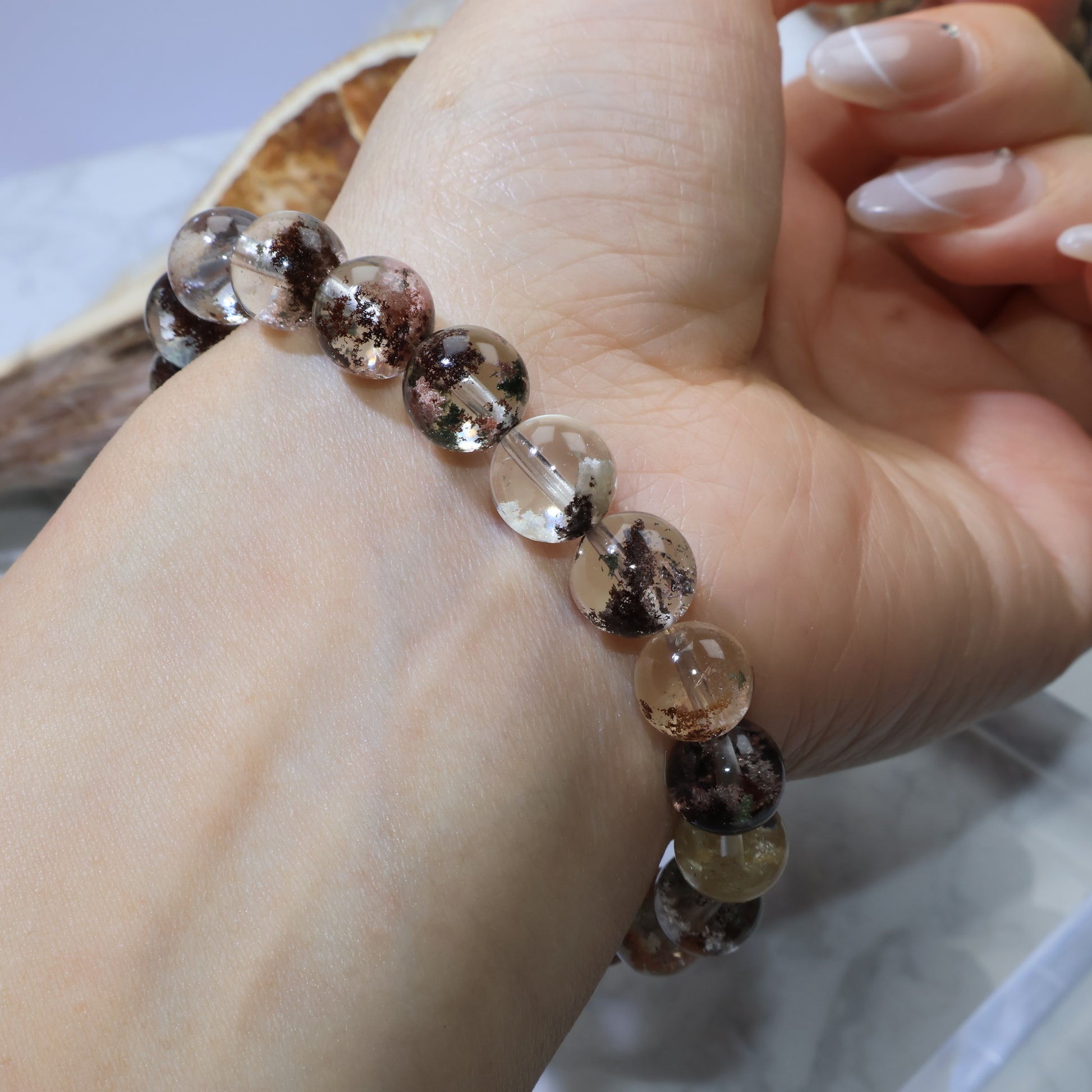 Scenic Phantom Quartz bracelet worn on wrist with dark and light phantom patterns