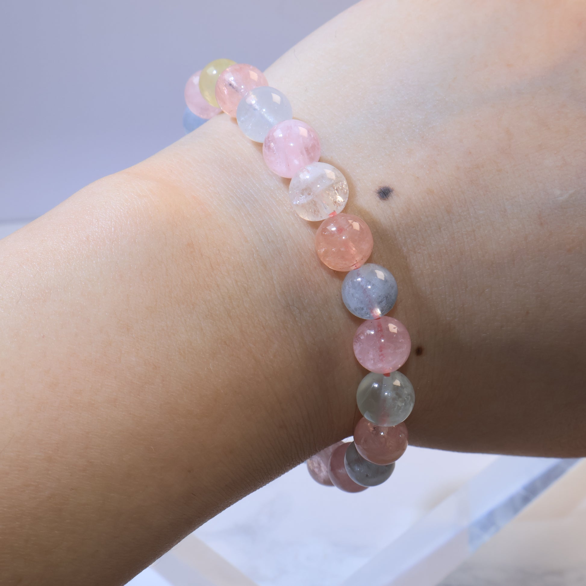 Wrist shot of Rainbow Morganite bracelet with pastel beads arranged evenly