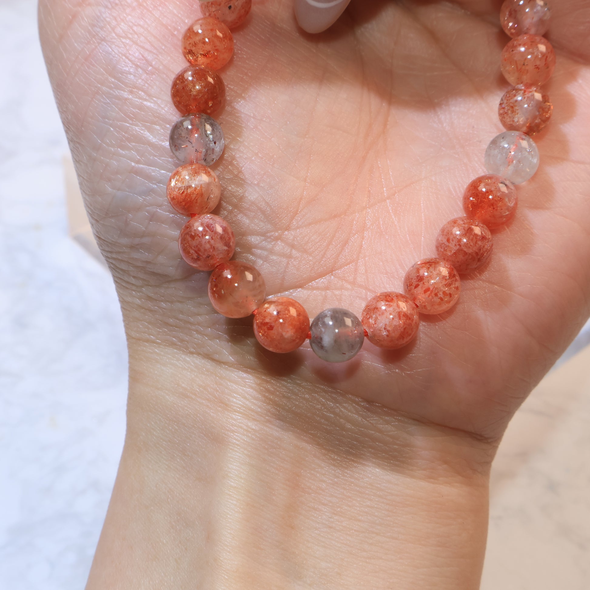 Close detail of Arusha Sunstone beads showing internal sparkle and natural variations