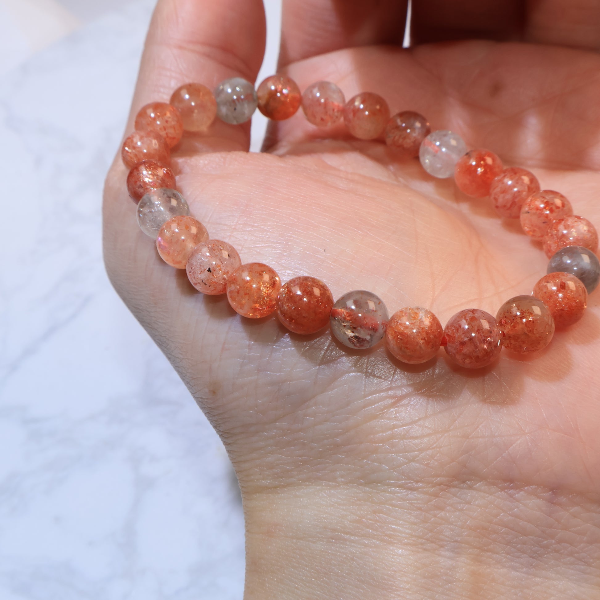 Angled wrist shot showing bracelet curve and bead shine