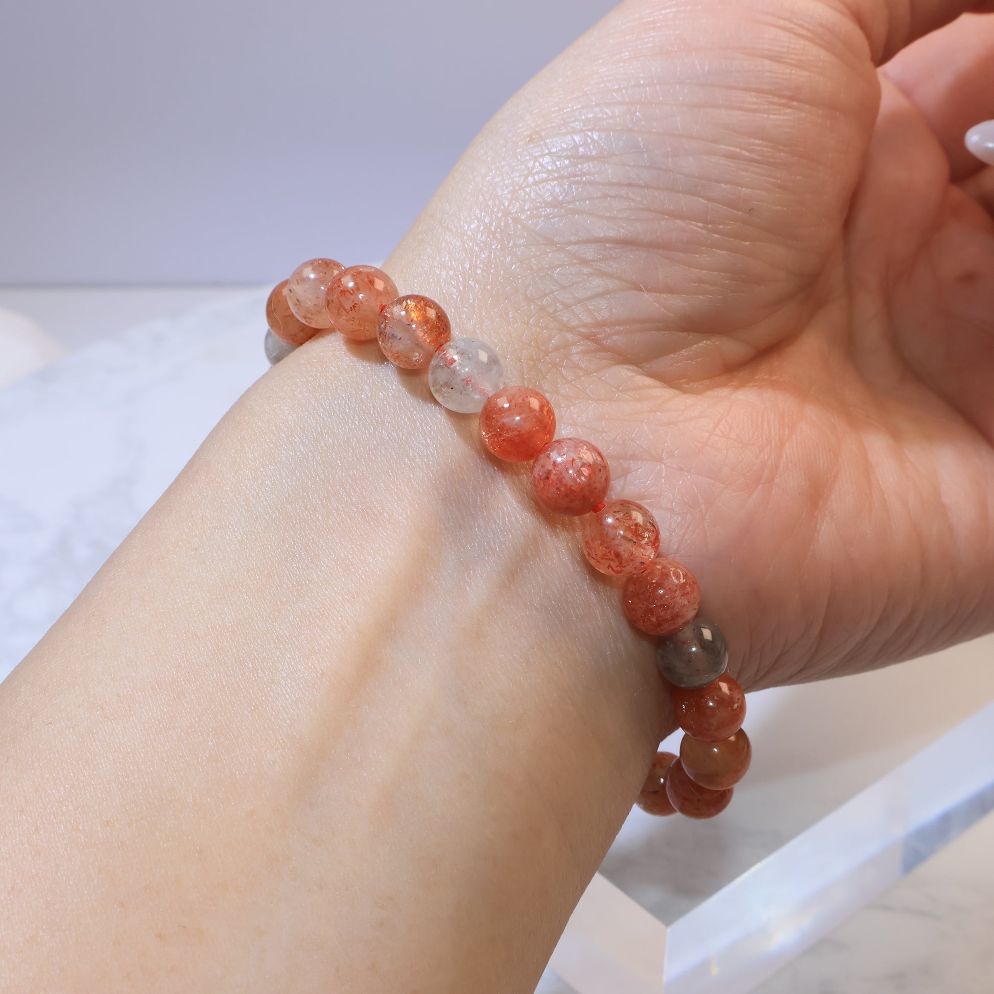Angled hand view showing full Arusha Sunstone bracelet circle