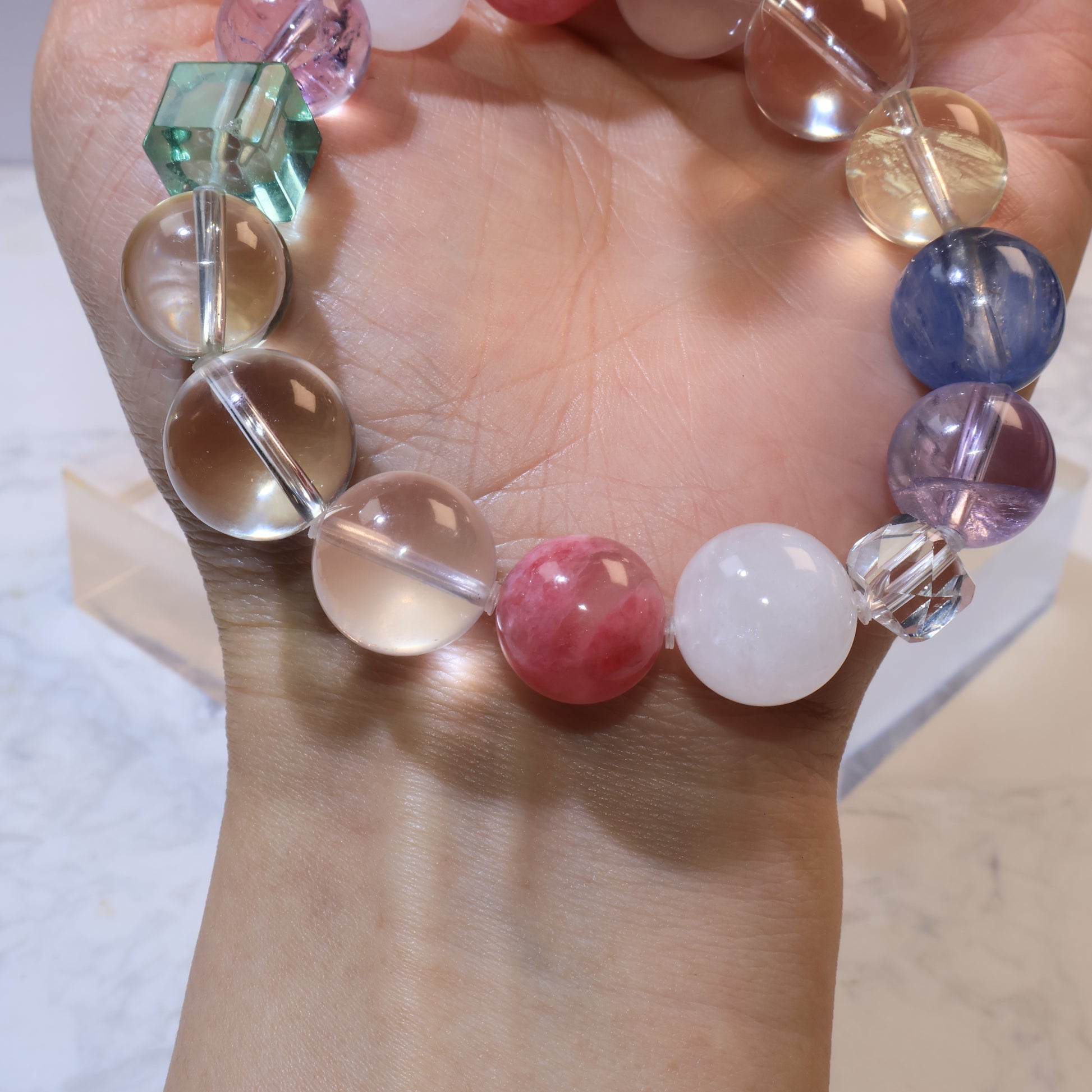 Bracelet looped on wrist showing transparent citrine and clear quartz beads