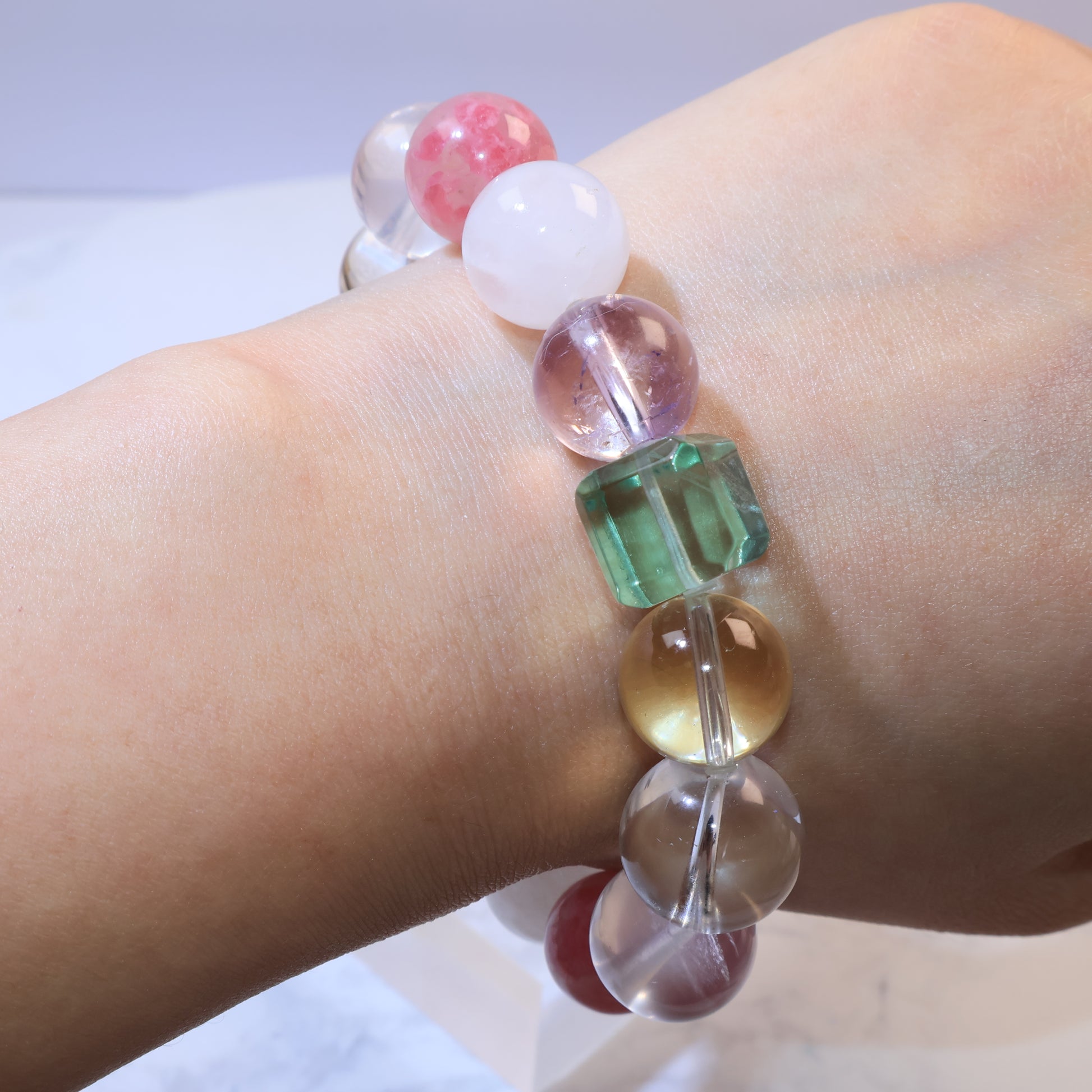 Side view of bracelet on wrist focusing on green fluorite and golden citrine