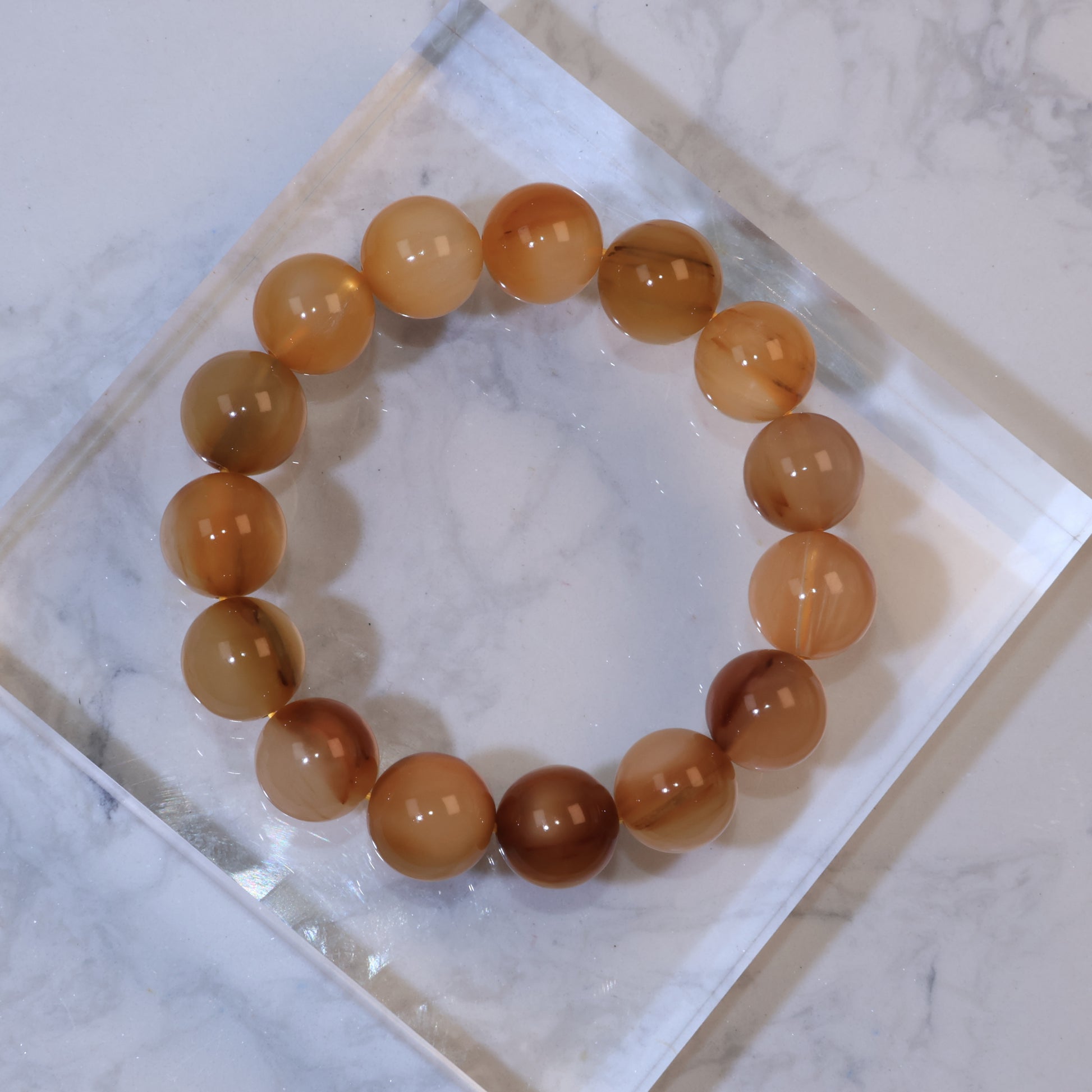 Close-up of Yellow Rabbit Hair Quartz bracelet with golden-yellow tones, fine internal filaments, and warm brown inclusions