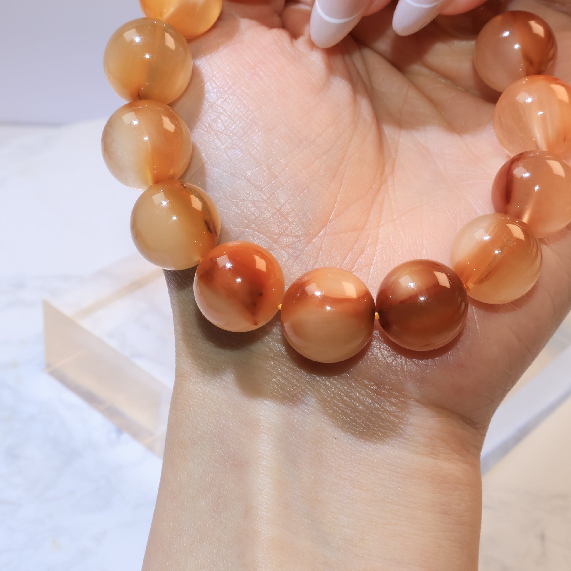 Side view of Yellow Rabbit Hair Quartz beads highlighting polished surface, transparency, and natural brown inclusions